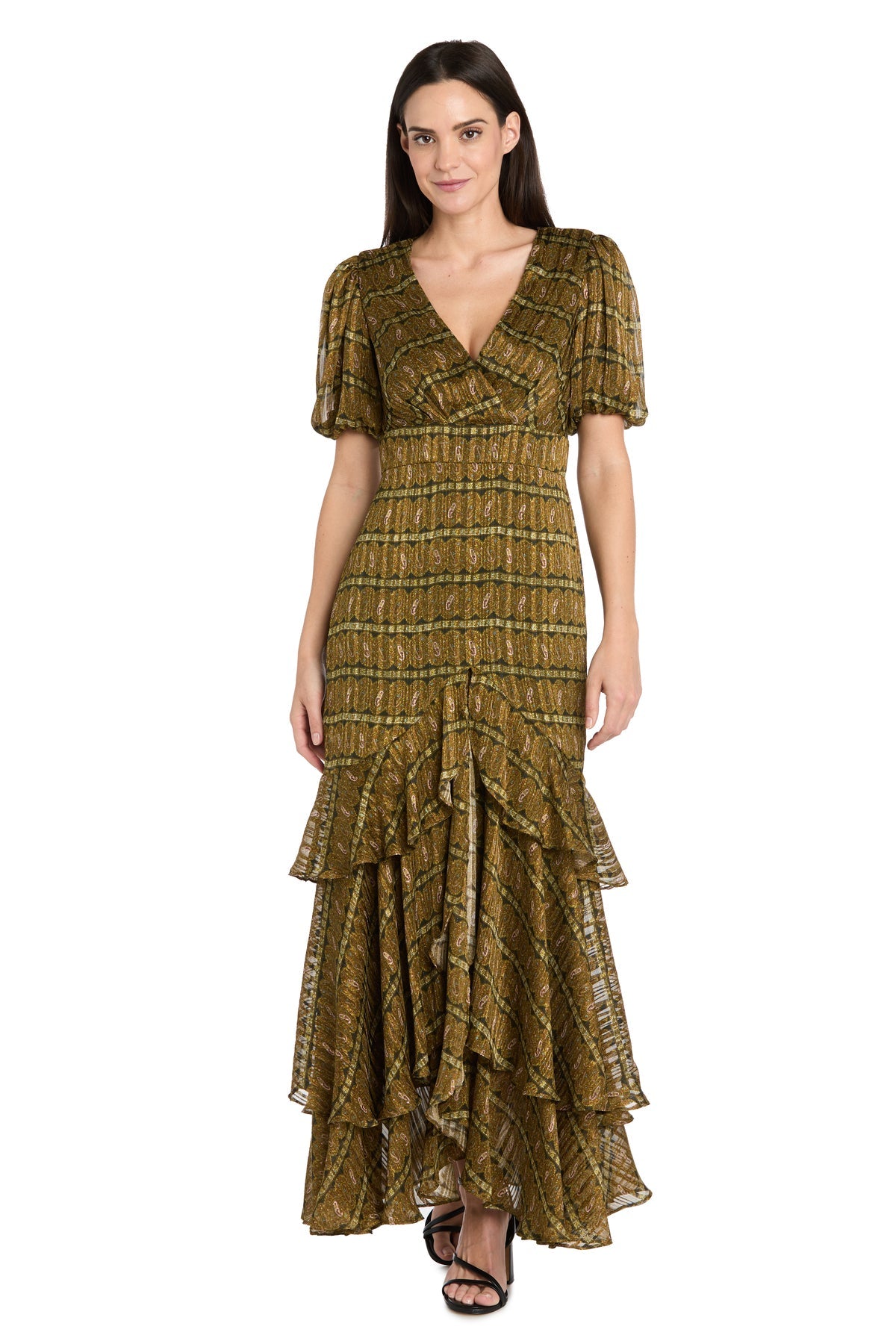 A woman wears the R&M Richards 4157 Long Plaid Wedding Guest Dress, featuring an olive green and brown pattern, short puff sleeves, V-neckline, and tiered ruffle hem, standing against a white background.