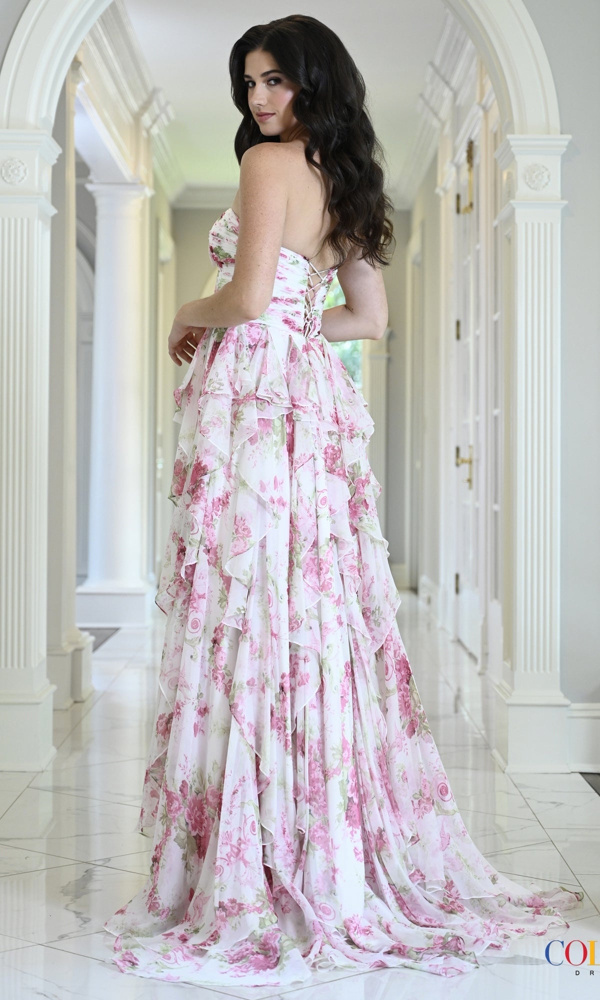 Colors Dress 4171 floor-length strapless dress in a pink and green floral print, featuring a lace-up back and ruffled skirt layers.