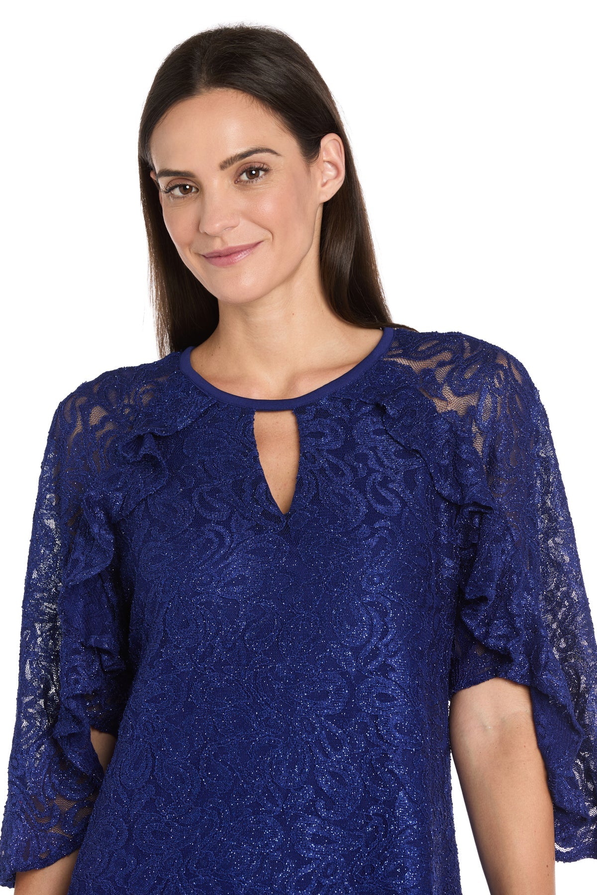 A woman with straight brown hair smiles slightly against a white background, wearing the R&M Richards 4226 Short Lace Semi-Formal Dress in royal blue, featuring ruffled sleeves and a keyhole neckline.