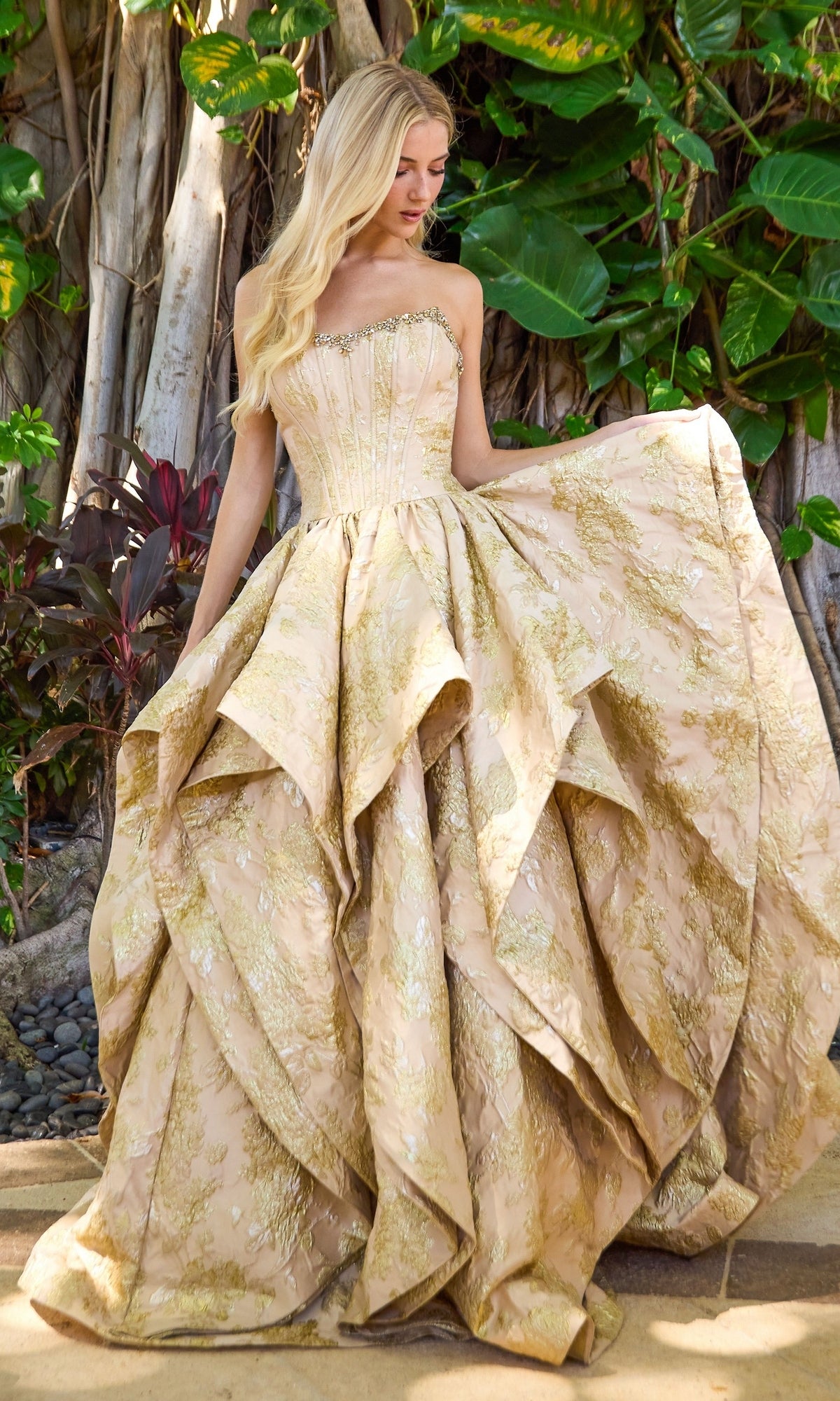 Long Prom Dress: Ava Presley 42541, a strapless ball gown with a corset bodice and a full, layered skirt in metallic gold floral fabric.