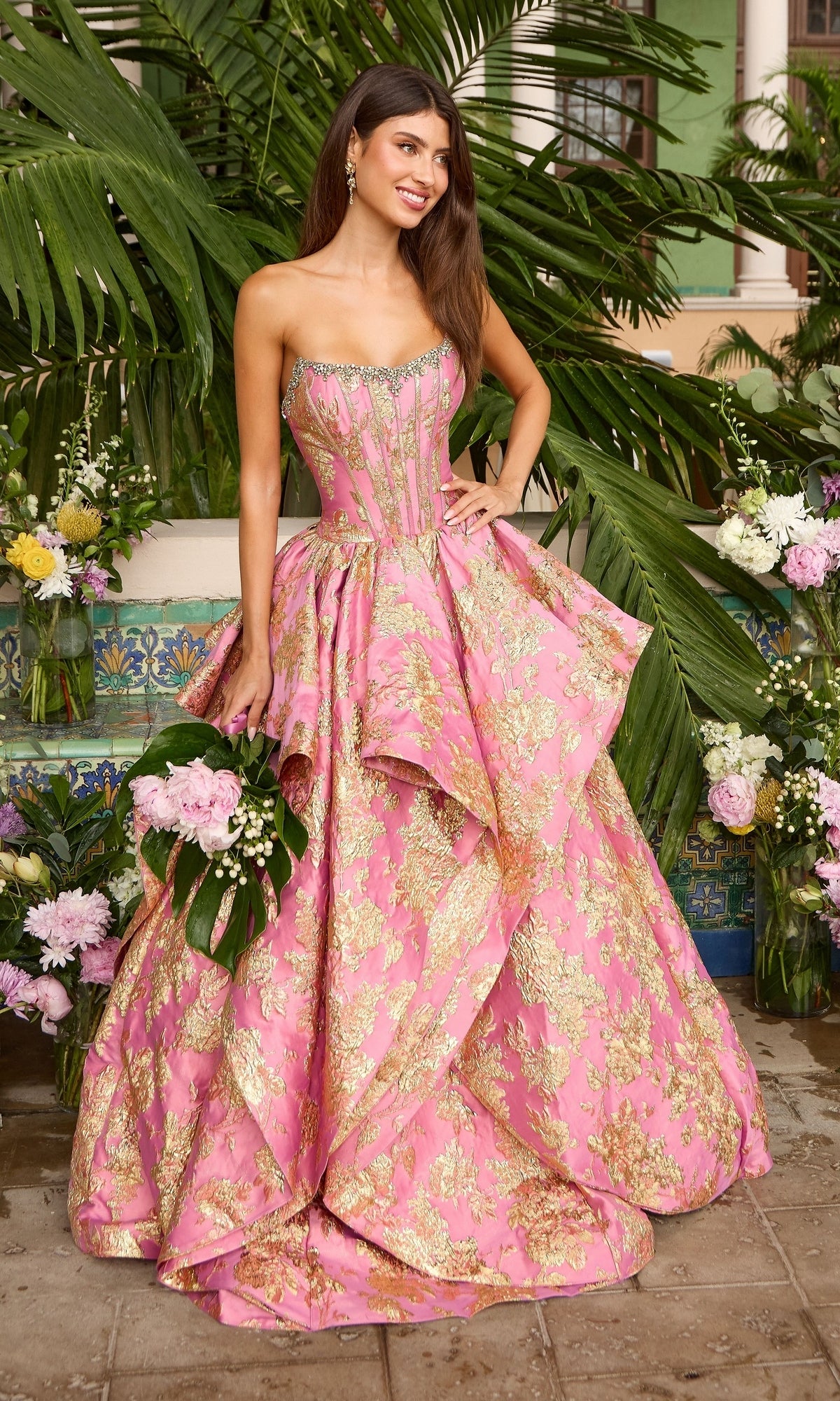 Ava Presley 42541 long prom dress in hot pink and gold, featuring a strapless metallic ball gown silhouette, gold floral patterns, and a crystal-embellished neckline.