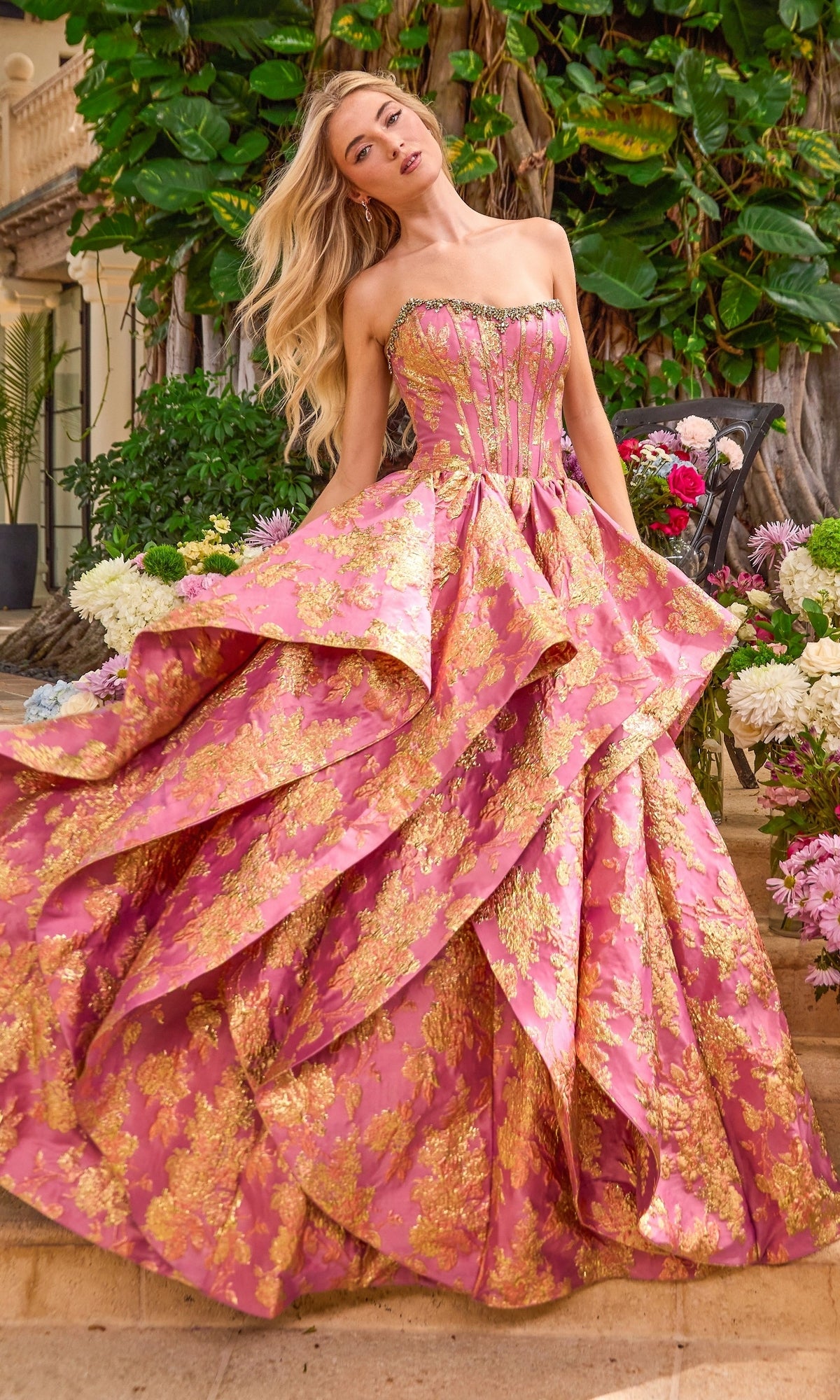 Long Prom Dress: Ava Presley 42541 strapless pink and gold floral print ball gown featuring a corset-style bodice and a layered, tiered skirt.