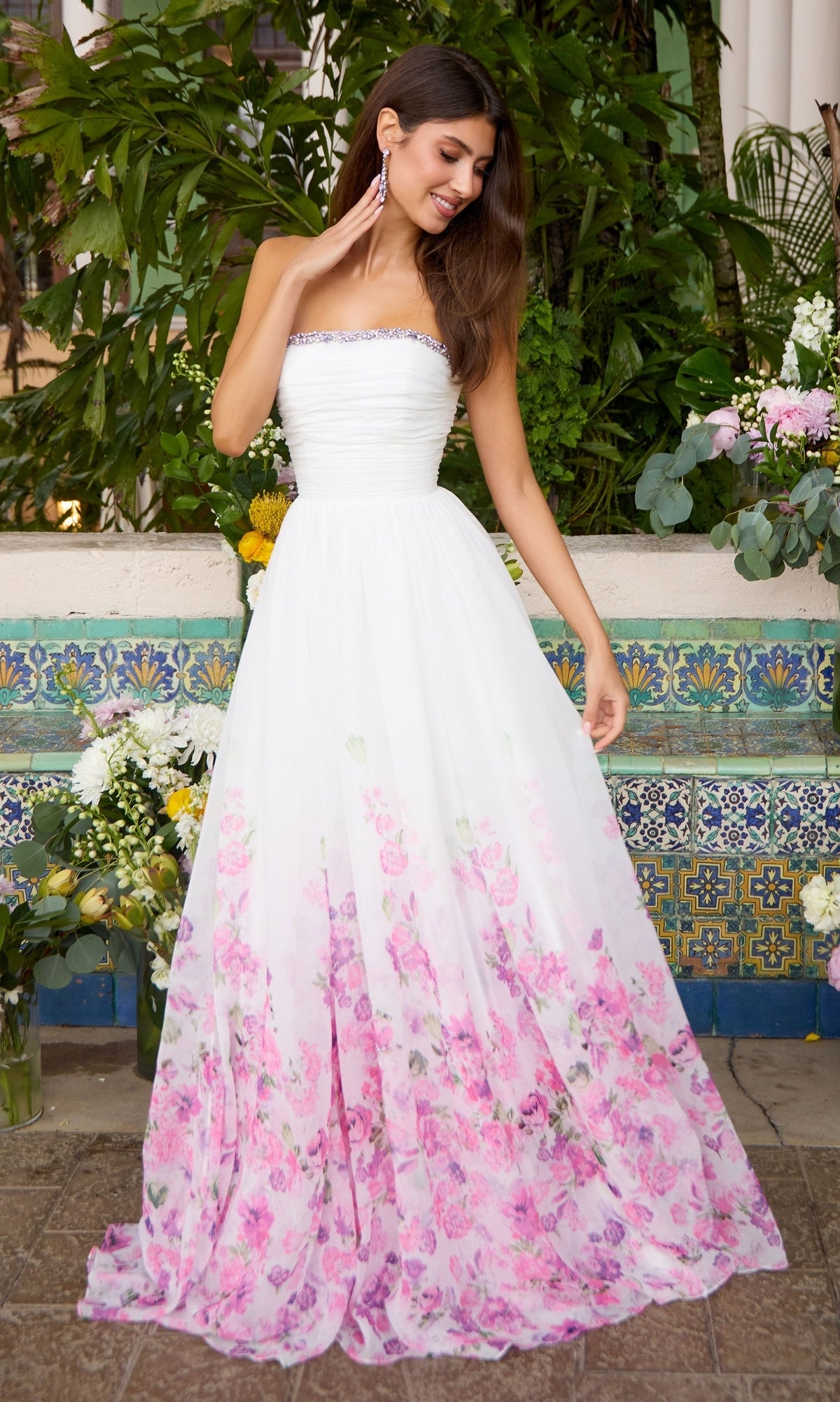 Ava Presley 43001 strapless white floor-length gown featuring a pleated bodice, embellished neckline, and a pink floral print on the A-line skirt.