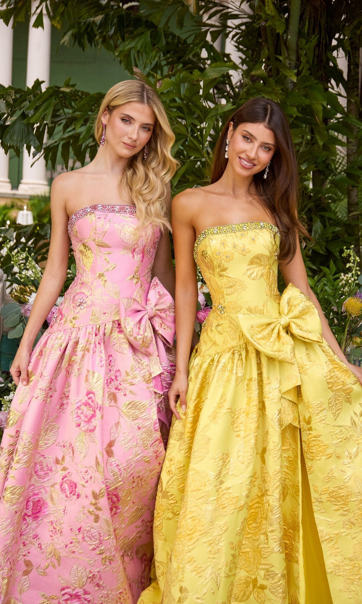 Two Long Prom Dress: Ava Presley 43103 ball gowns in pink and yellow, featuring strapless, floor-length silhouettes with gold floral patterns and large bows at the waist.