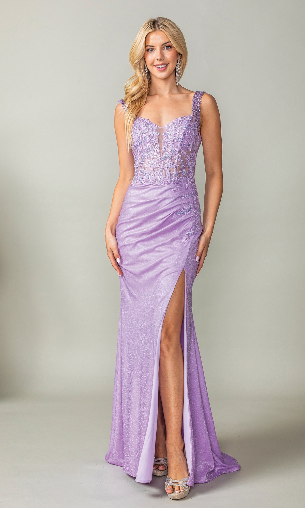 A woman wears the Embellished Sheer-Corset Long Prom Dress 4400, a sleeveless, floor-length lavender gown with a thigh-high slit and lace details, standing against a plain light gray background.