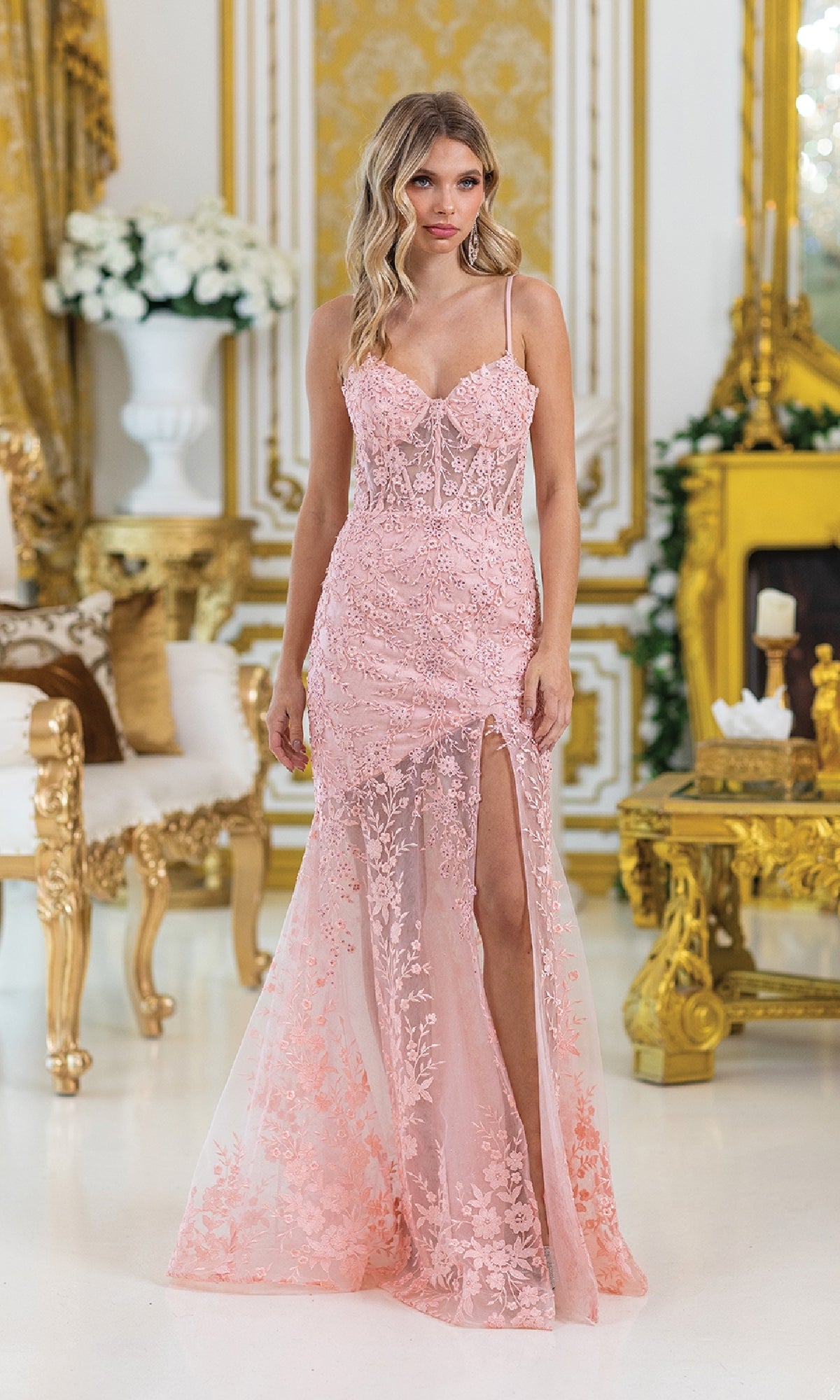 Wearing the Beaded-Floral Long Prom Dress: Dancing Queen 4501 in light pink, a woman stands in an ornate room adorned with gold accents and beaded flowers.