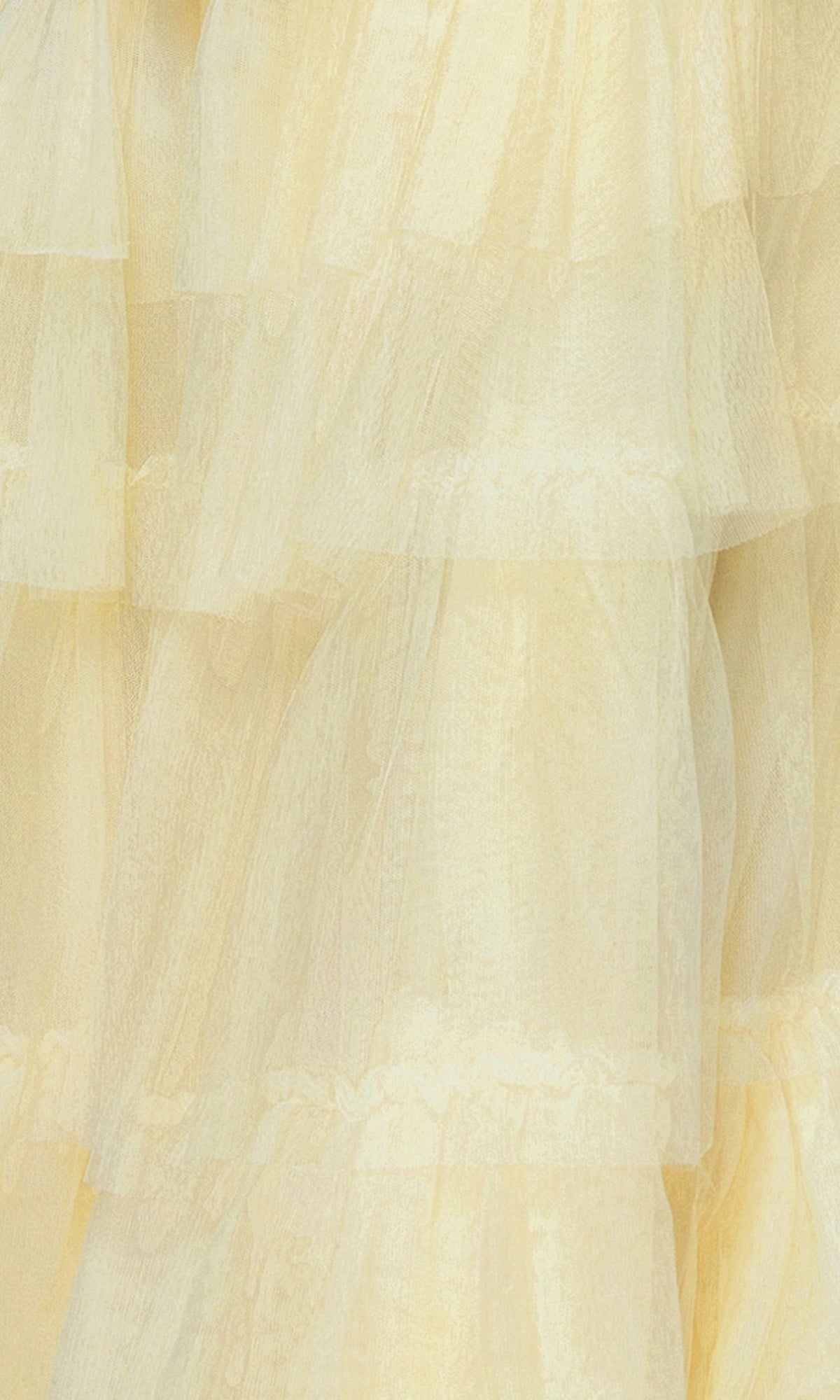 Close-up of sheer yellow fabric with a soft, textured look—ideal for the Long Ruffled Prom Dress: Blondie Nites 4637BN, featuring layered ruffles and a sweetheart bodice in an elegant A-line silhouette.