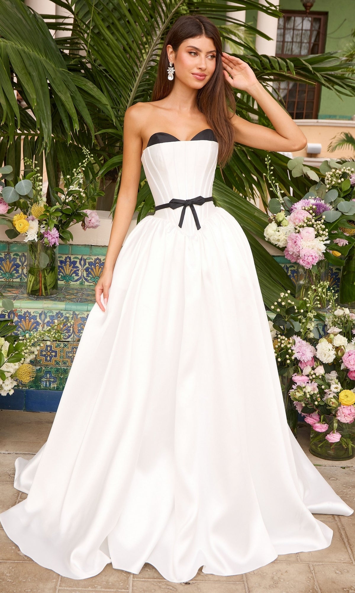 Ava Presley 47365 strapless white floor-length ball gown featuring a black bodice trim and a black waist ribbon.