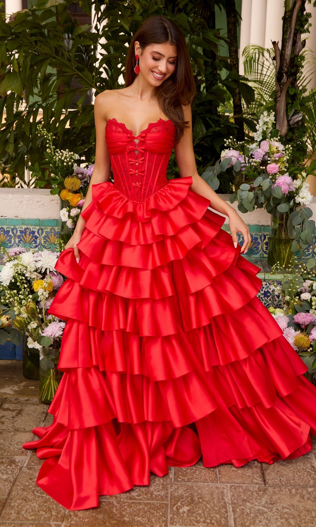 Ava Presley 47372 strapless red corset prom dress featuring a bodice with a voluminous, multi-tiered ruffled skirt.