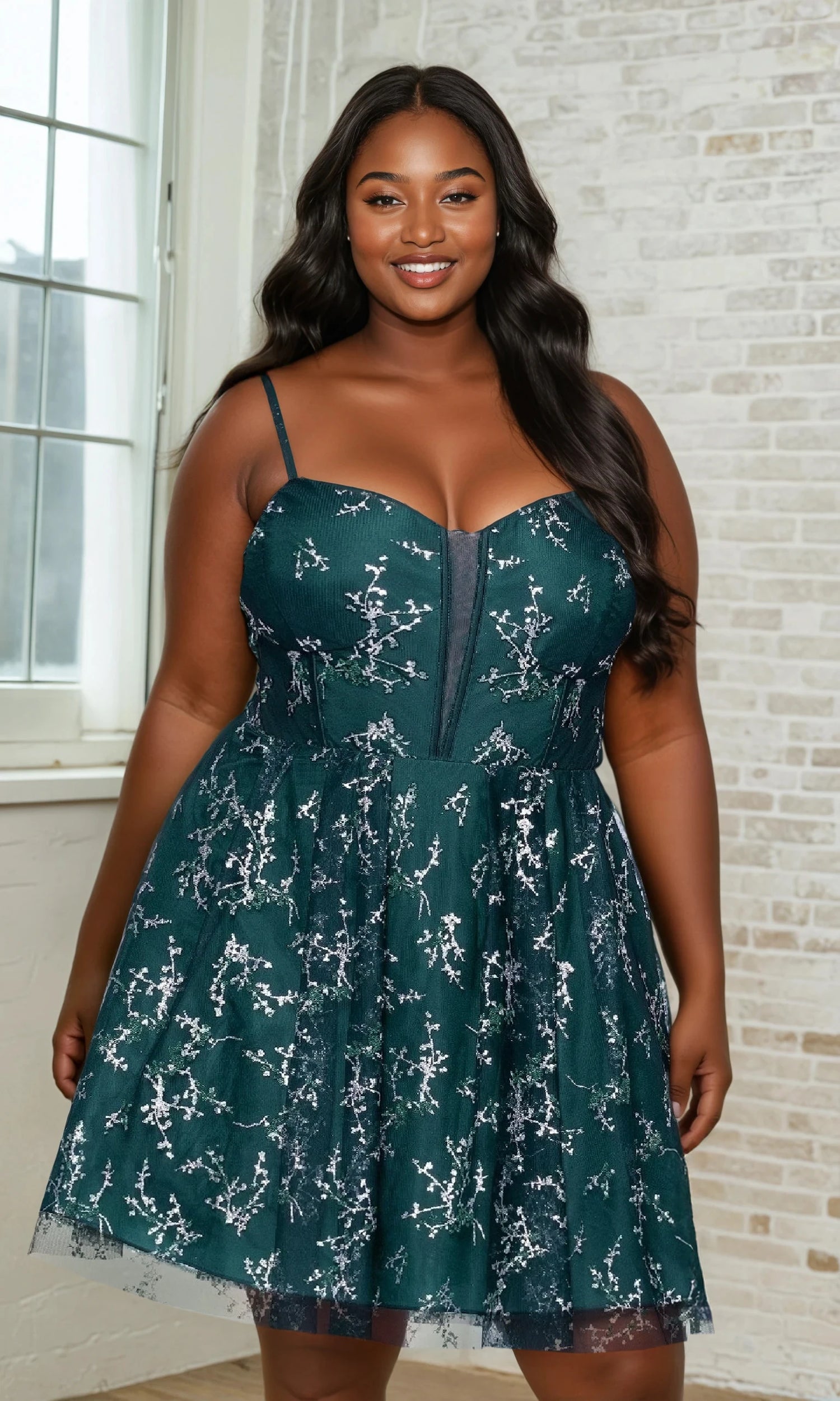Woman wearing a green floral dress standing indoors.