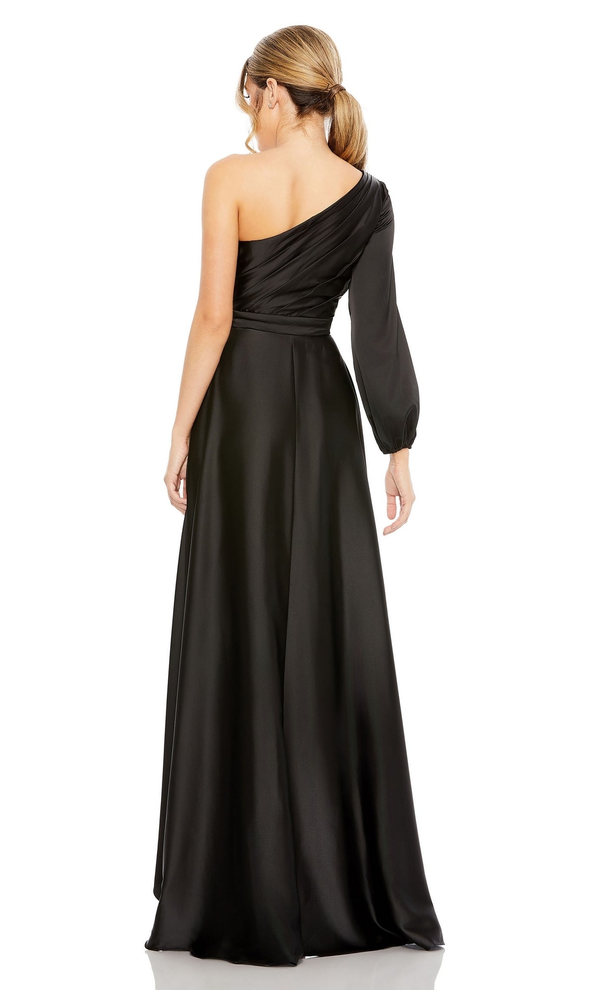 A woman stands facing away from the camera in the Mac Duggal 49141 One-Sleeve High-Low Prom Dress, a long black formal gown with a single long sleeve and one-shoulder design.