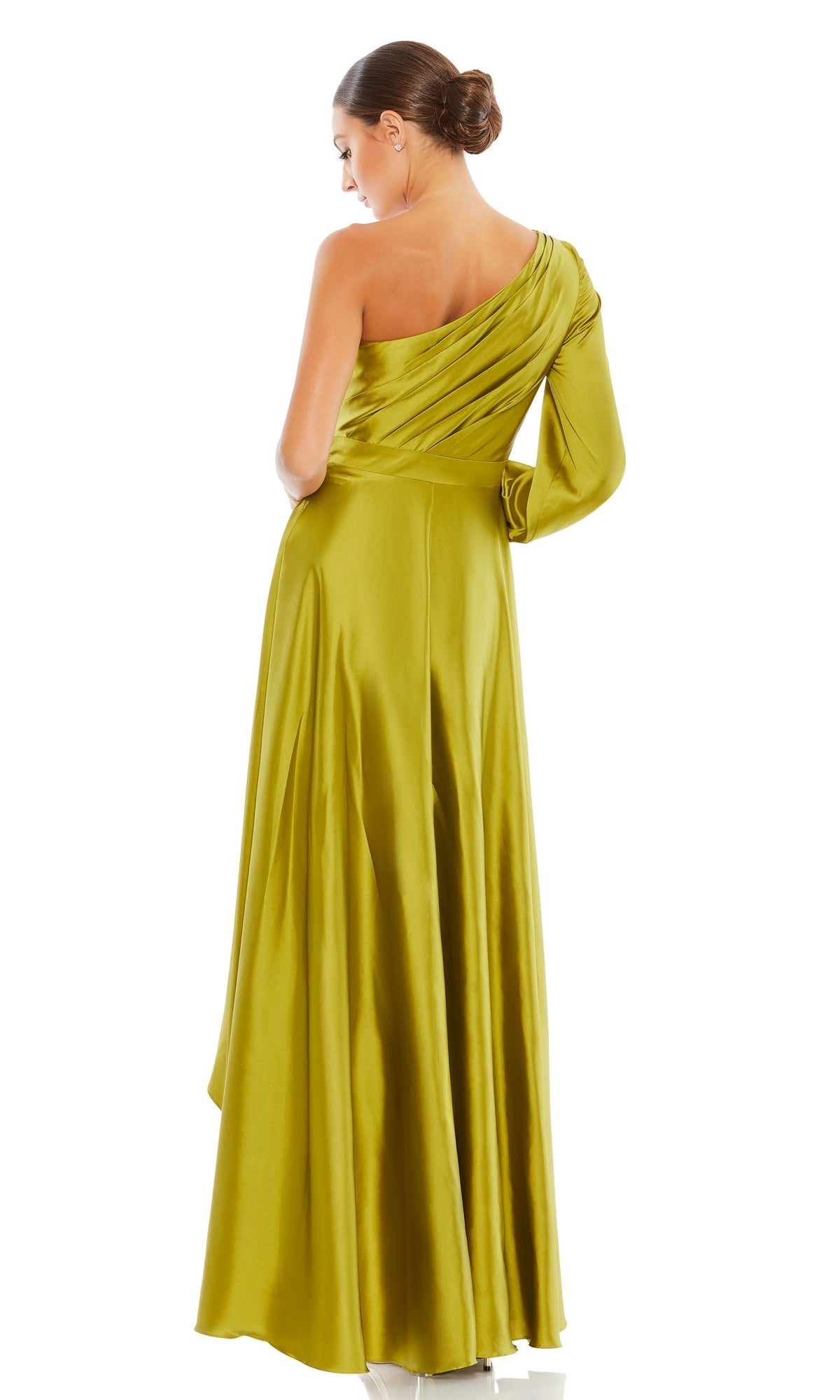 A woman in a one-sleeve, high-low olive-green Mac Duggal 49141 prom dress stands with her back to the camera, her hair in a low bun.