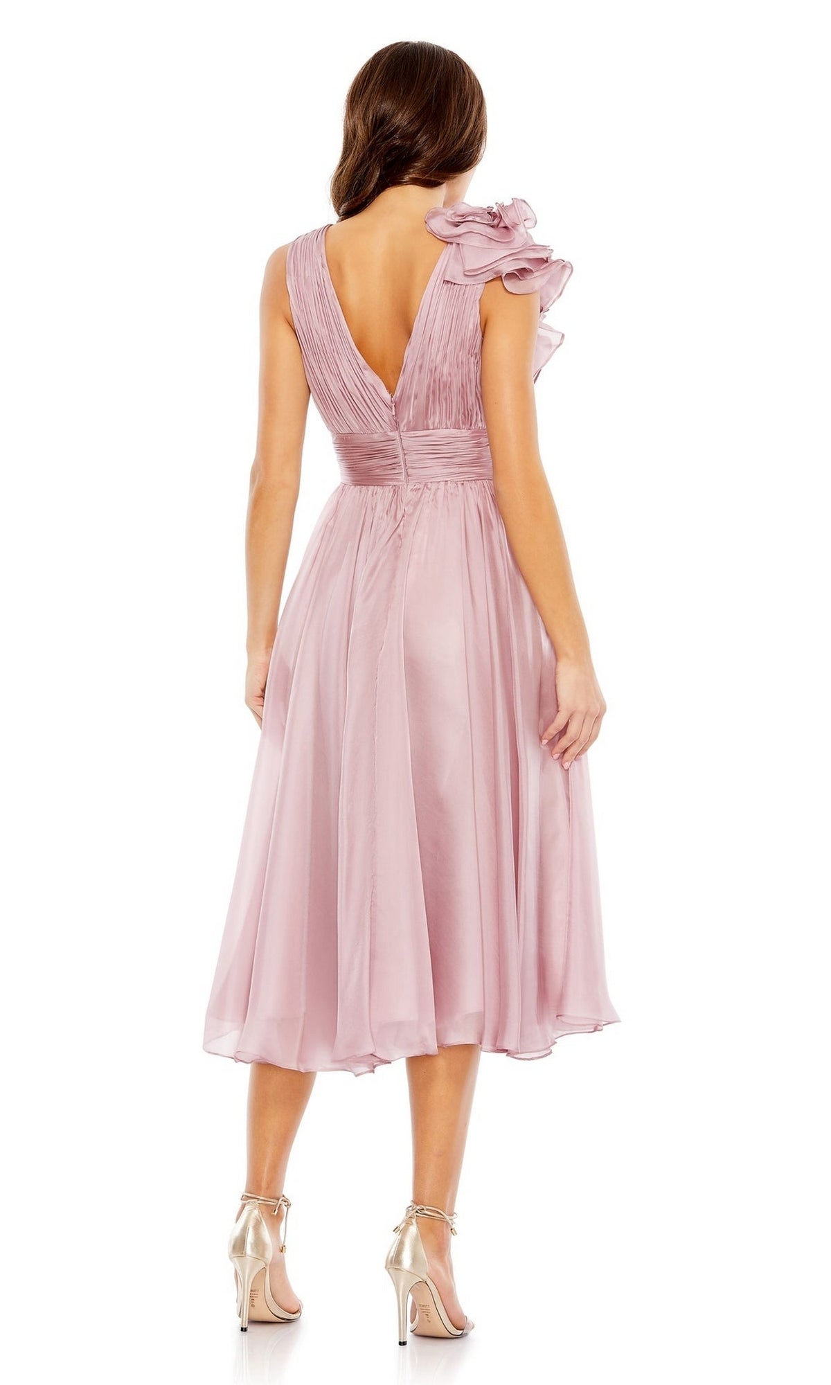 Woman wearing the Mac Duggal 49494 Short Ruched Wedding-Guest Dress in light pink, featuring ruffle shoulders and a knee-length back view, paired with metallic high-heeled sandals.