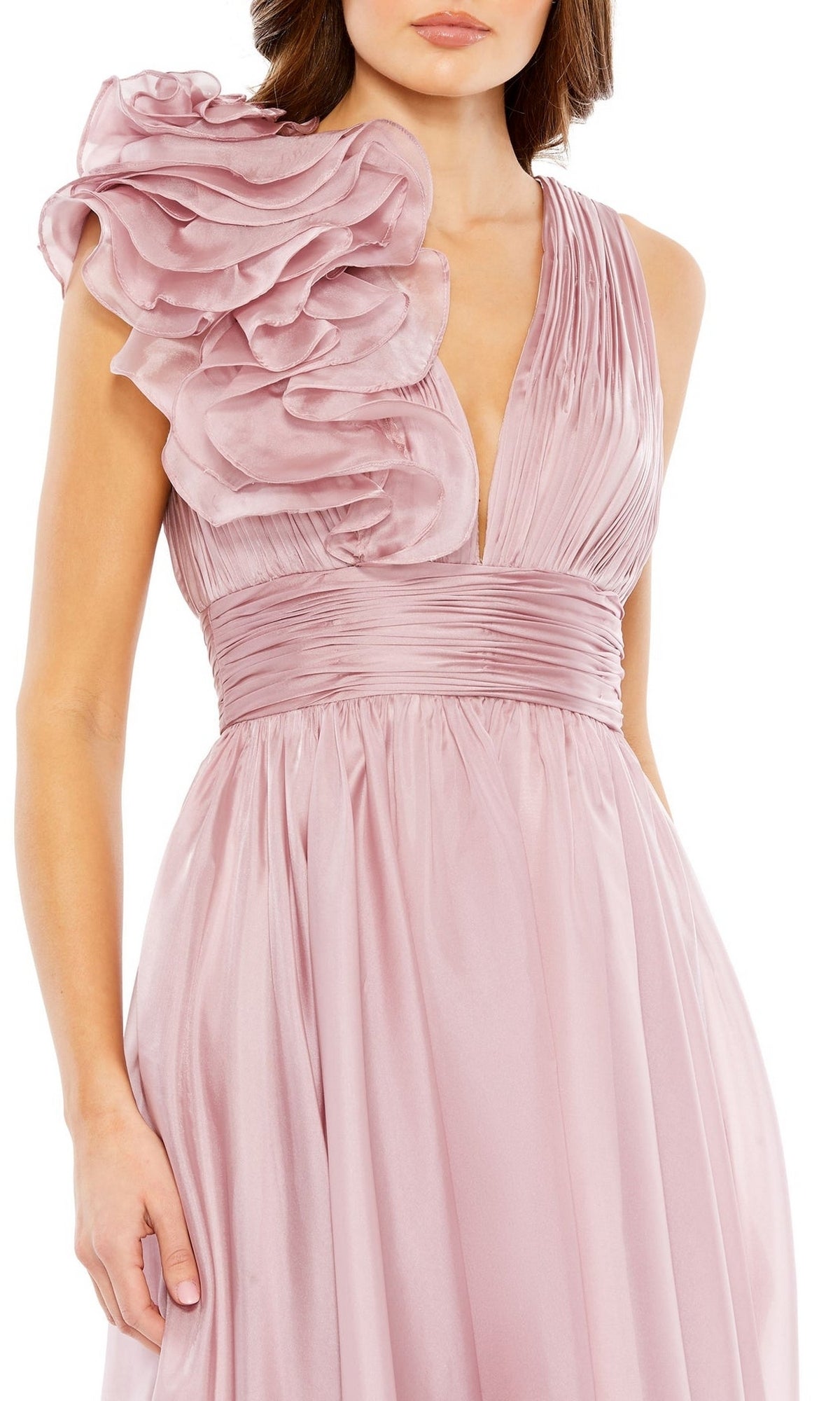 A woman wearing the Mac Duggal 49494 short ruched wedding-guest dress, featuring a sleeveless design, deep V-neckline, pleated bodice, wide waistband, and a striking one-shoulder ruffle detail.