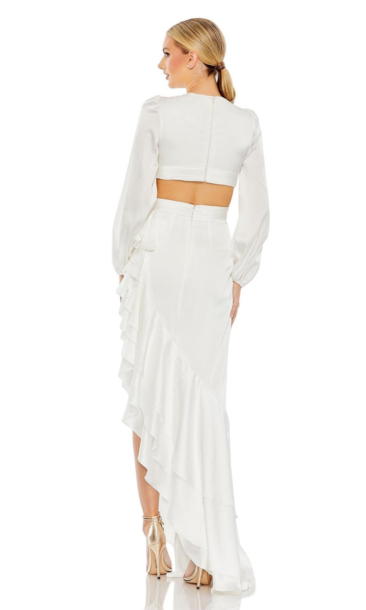Woman in a Mac Duggal 49524 long sleeve high-low party dress, featuring a ruffled skirt, standing and facing away, paired with nude high heels.