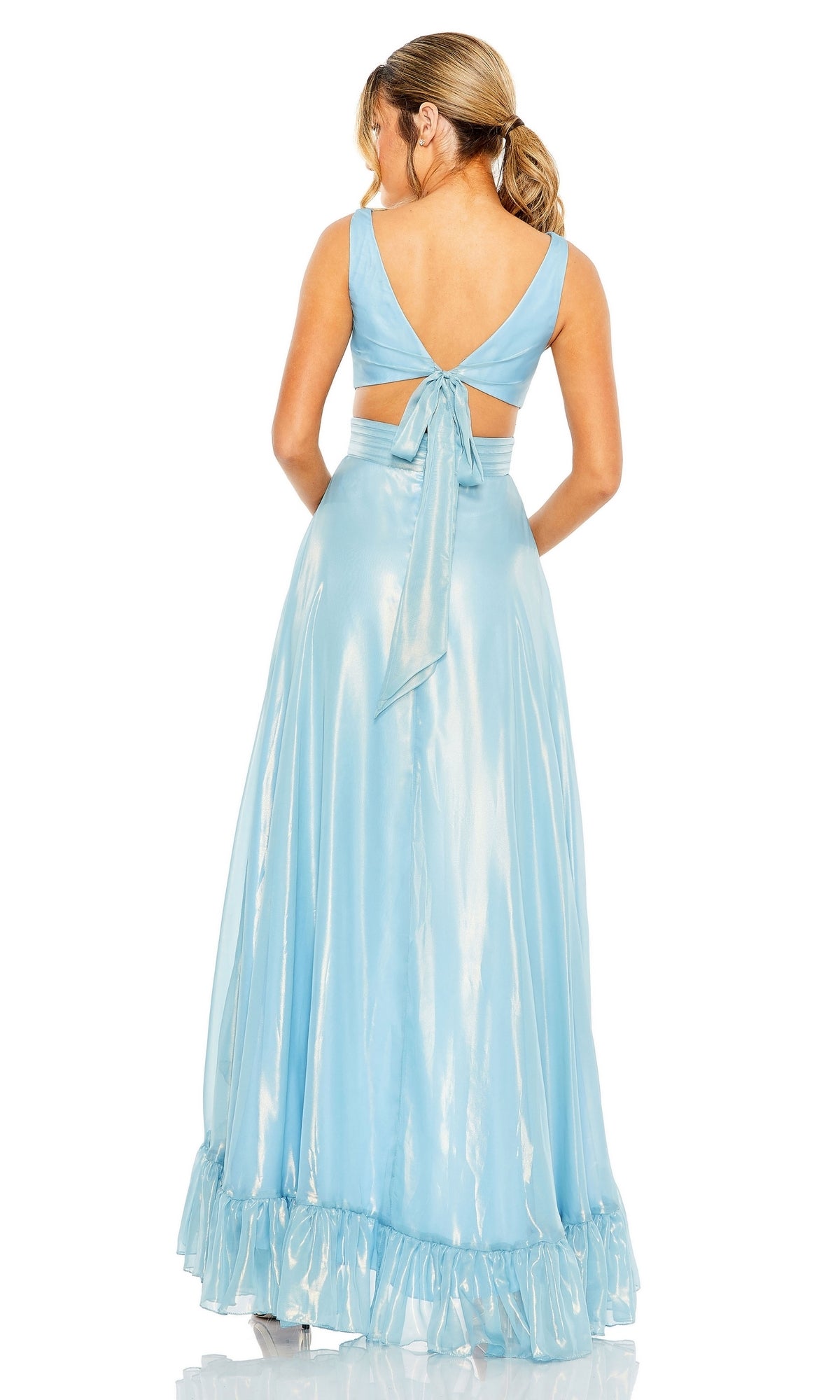 Woman models the Mac Duggal 49526 Ruffled High-Low Formal Dress in shiny light blue, featuring a deep V-back, tie detail, and ruffled hem as she faces away from the camera.