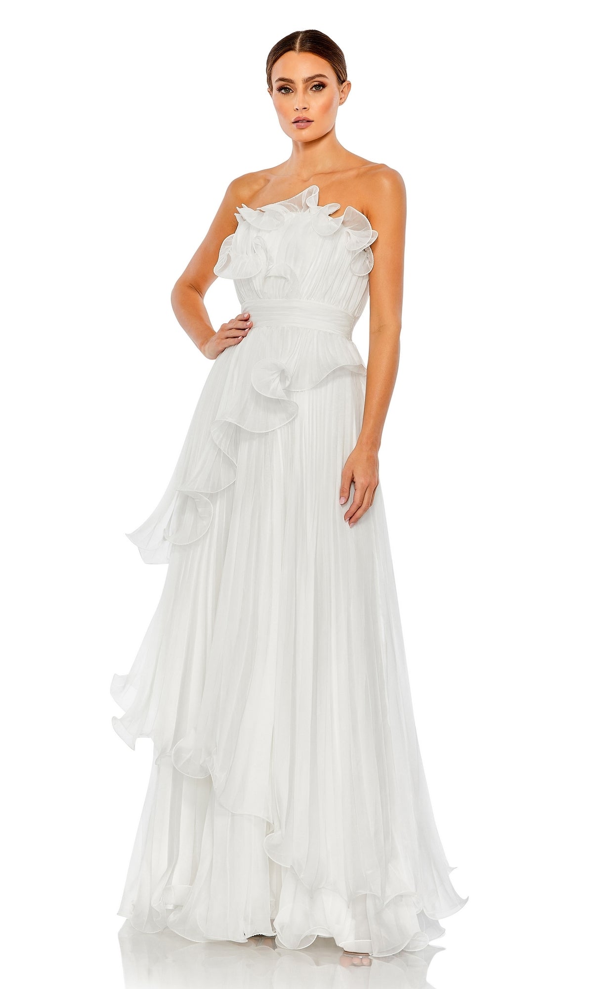 A woman models the Long Formal Dress 49537 by Mac Duggal, a floor-length, one-shoulder white gown with ruffle and pleated A-line details, standing against a plain white background.