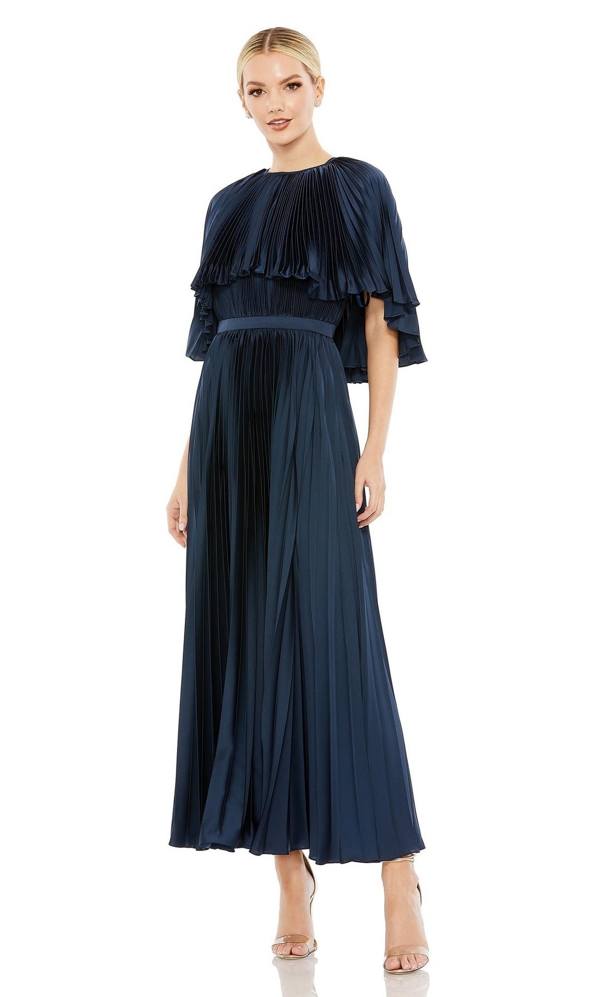 Woman in the Mac Duggal 49638 Caped Tea-Length Party Dress, dark blue with pleats and short layered sleeves, styled with neutral heels against a white background.