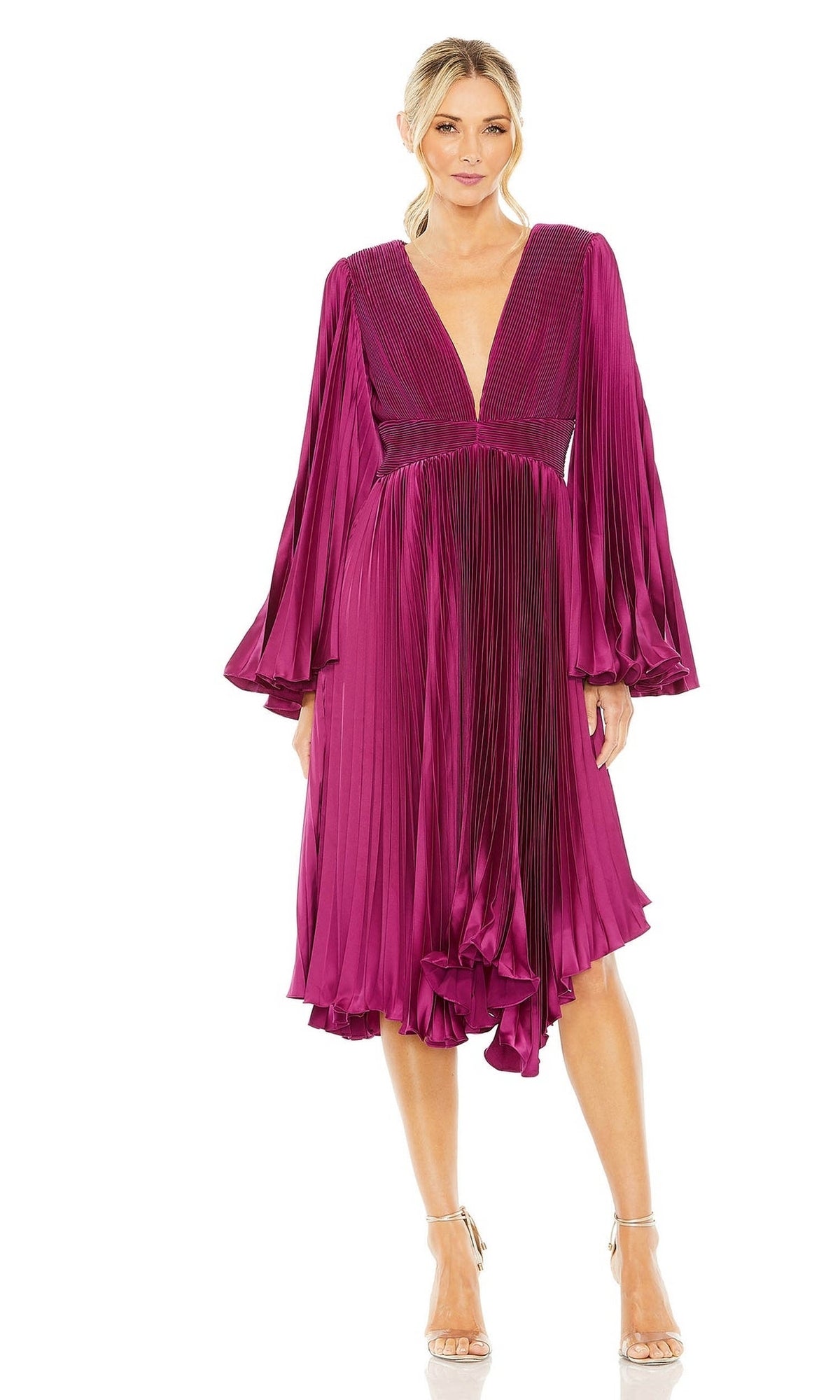 A woman wears the Berry Red Wedding Guest Dress: Mac Duggal 49717, featuring long sleeves, a deep V-neck, pleated details, a knee-length hem, and strappy high-heeled sandals.