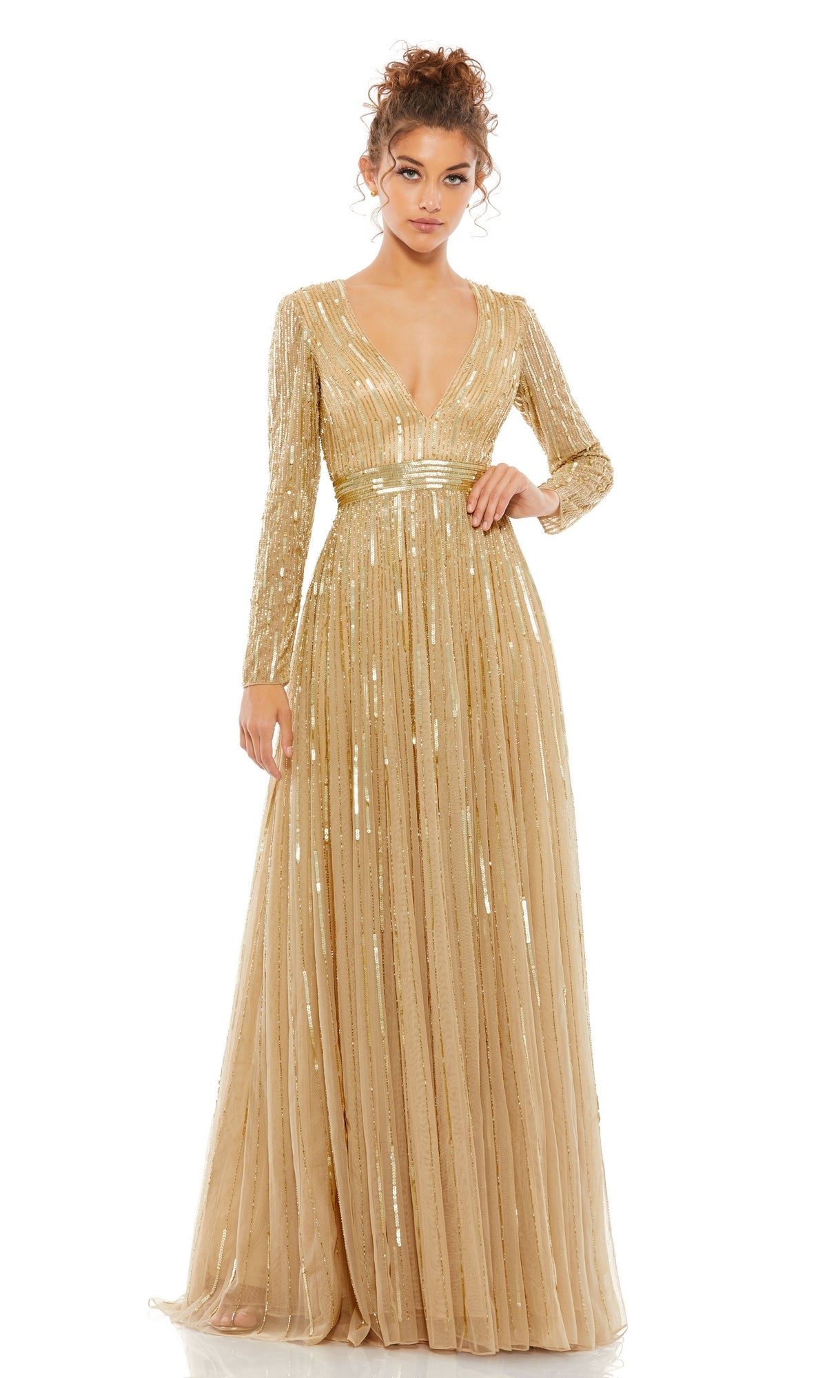A woman poses against a plain white background wearing the Long Formal Dress 4977 by Mac Duggal, featuring gold shimmering sequins, long sleeves, and a deep v-neckline.