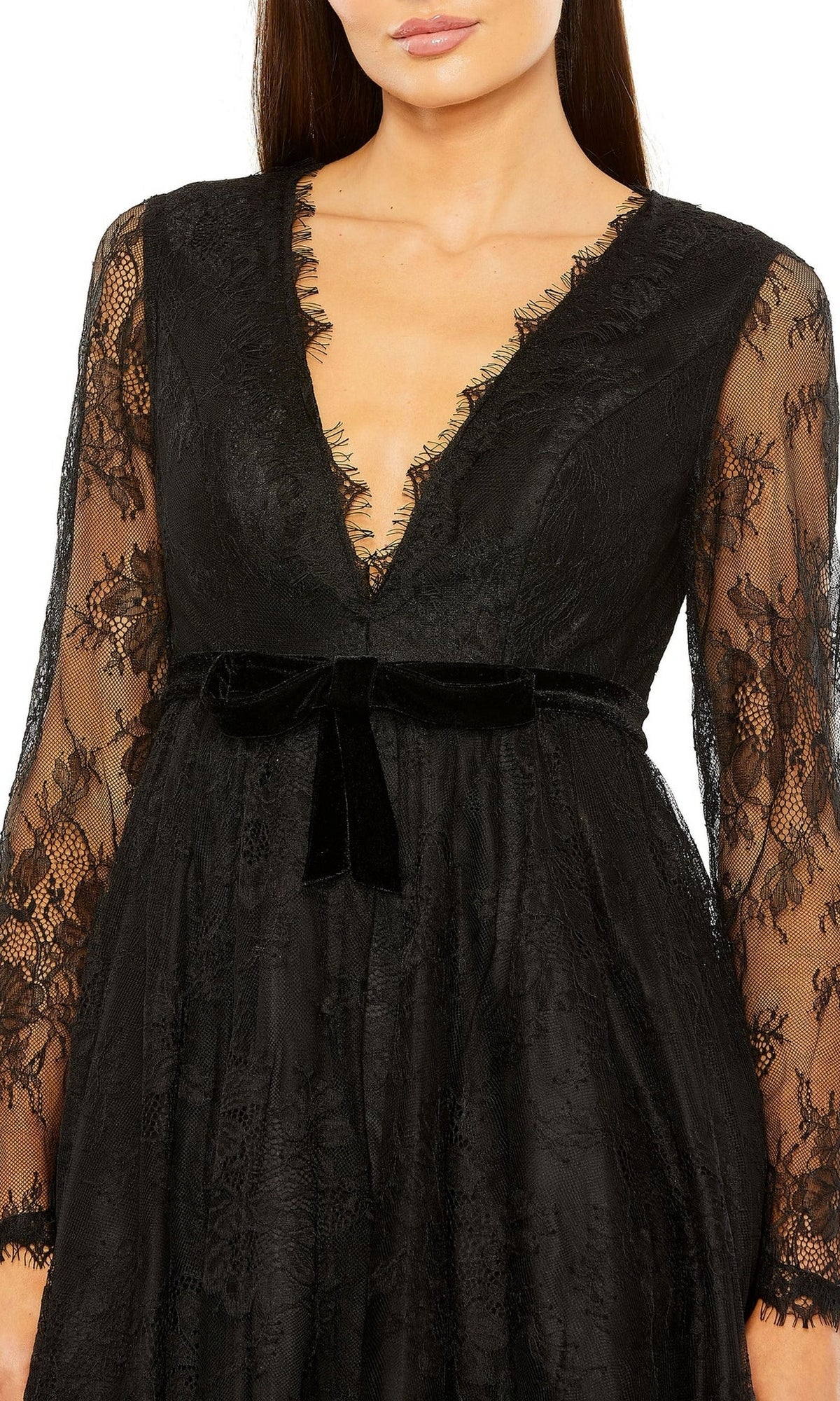 Woman in the Mac Duggal 49794 short black wedding guest dress—long sleeves, black lace, deep V-neckline, and a velvet waist bow create an elegant event-ready look.