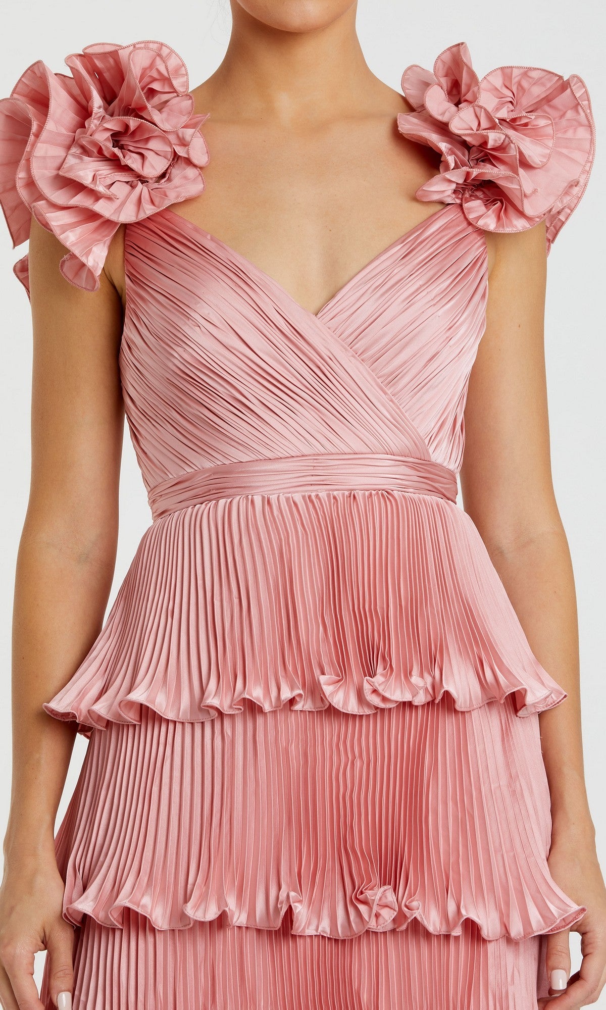 Woman wearing the Mac Duggal 49983 Long Formal Dress—a sleeveless pink gown featuring ruffled shoulder details and a tiered pleated skirt.