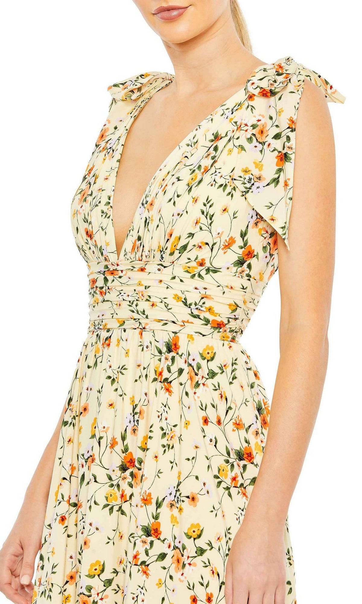 A woman wears the Long Formal Dress 50657 by Mac Duggal, a sleeveless, cream, v-neck a-line dress decorated with an orange and green floral pattern.