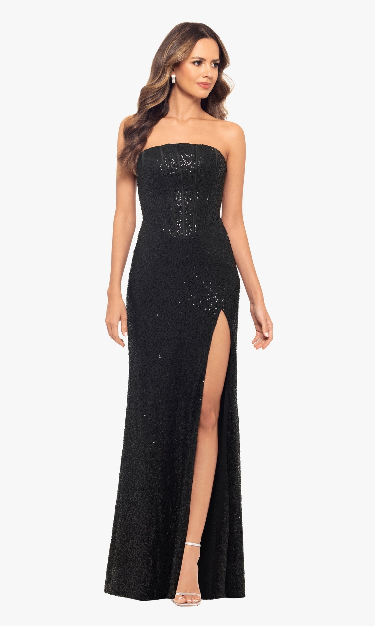 A woman stands facing forward, wearing the Blondie Nites 5181BN Sequin Long Black Prom Dress—strapless, floor-length with a thigh-high slit.