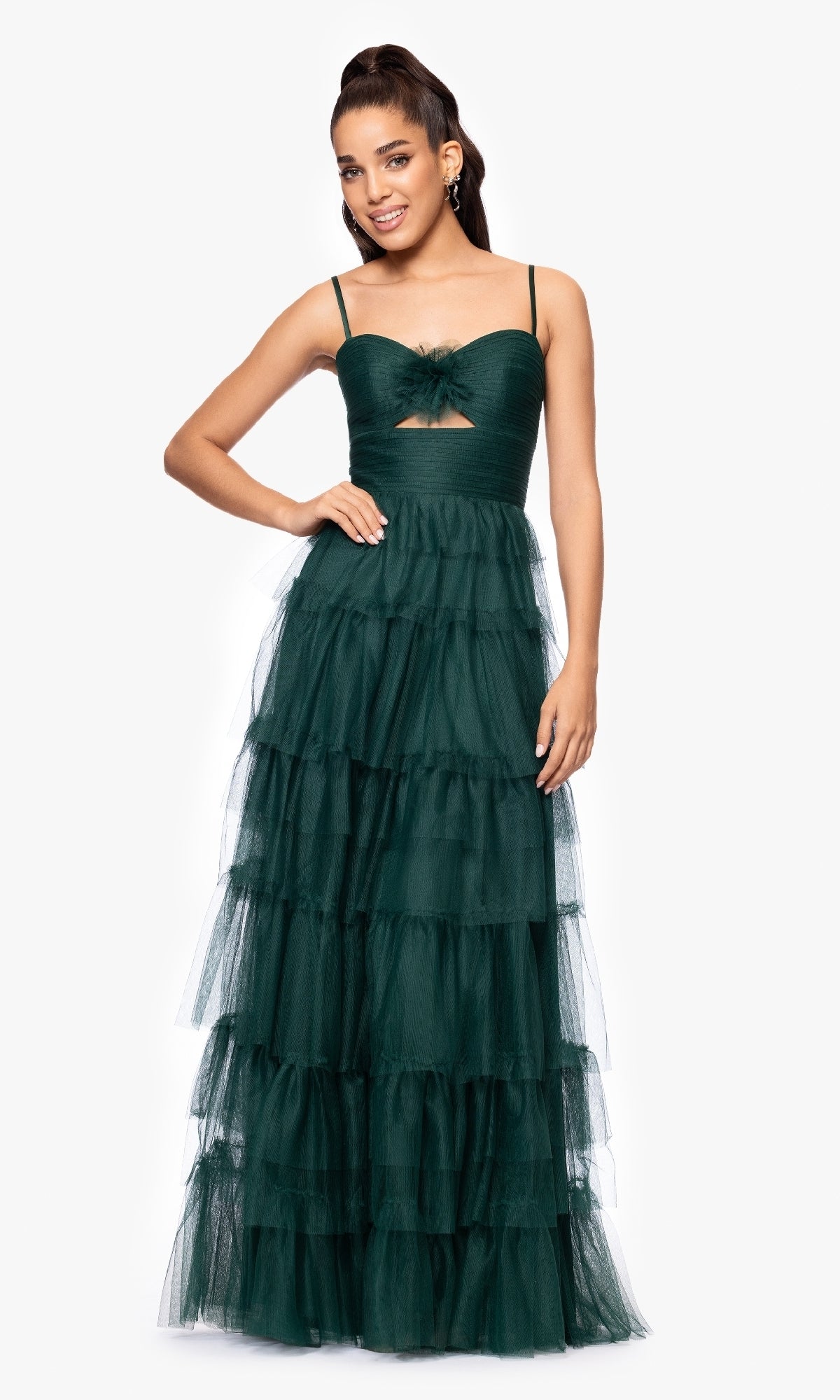 A woman wears the Dark Green Ruffled Prom Gown, Blondie Nites 5183BN—sleeveless with thin straps, a small front cutout, ruffled A-line bodice, and tiered tulle skirt—standing against a plain white background.