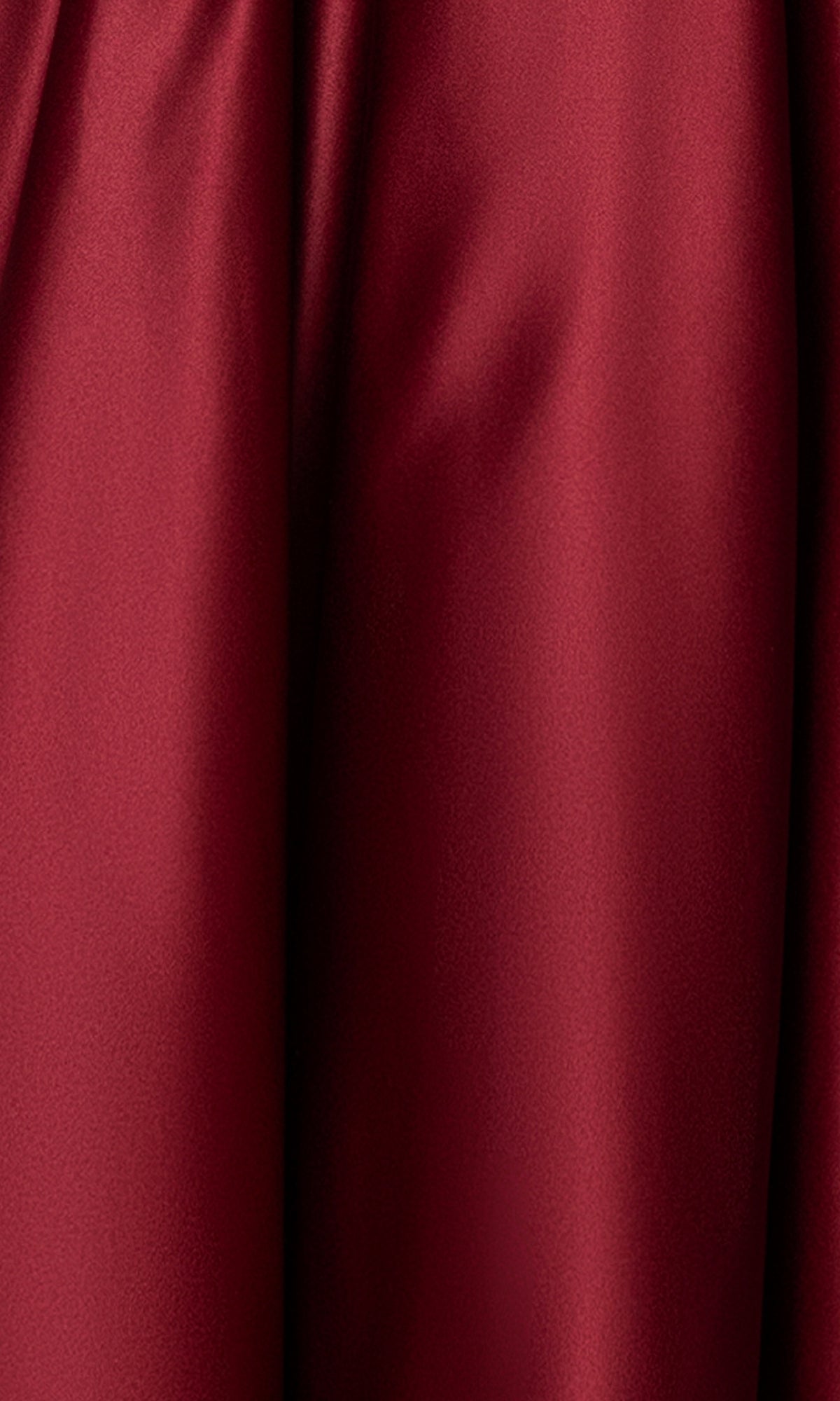 Close-up of smooth, deep red satin fabric with soft folds and light reflection—ideal for the Long Prom Dress: Blondie Nites 5207BN, featuring a flattering corset bodice and A-line silhouette, all for under $200.