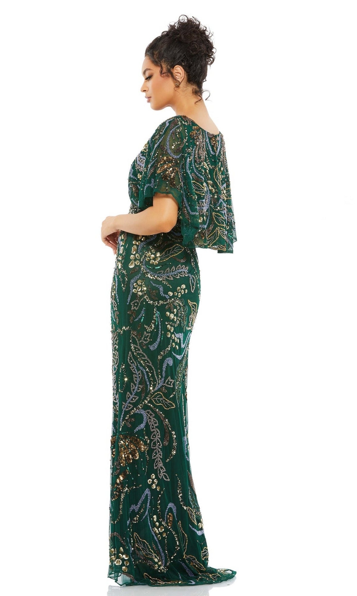 Woman wearing the Long Formal Dress 5239 by Mac Duggal—an emerald green gown with a v-neckline and sequined paisley patterns—stands in profile against a white background.