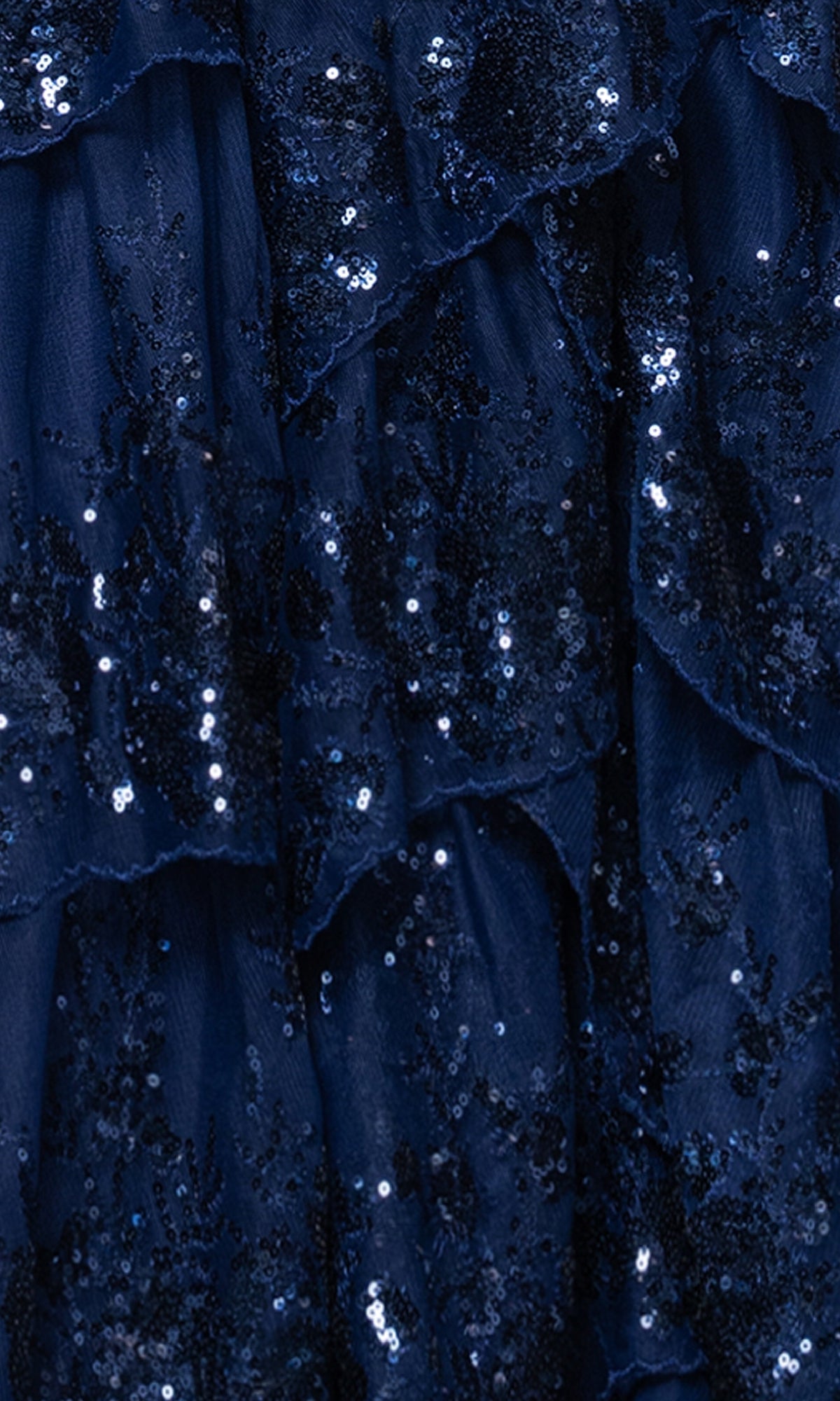 Close-up of layered navy blue fabric with sequins, lace appliques, and ruffled textures—ideal for the Long Navy Prom Dress: Blondie Nites 5394BN, featuring a shimmering tiered A-line skirt.