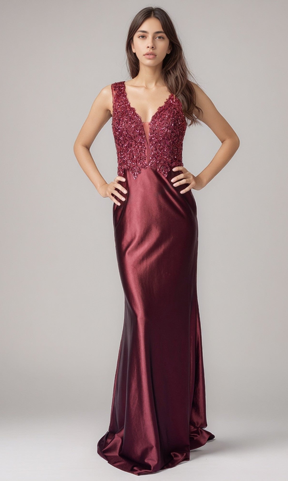 A woman wears the Nina Canacci 5411 long formal dress in wine, featuring a sleeveless design with an embellished bodice and satin floor-length skirt, posed against a plain background.
