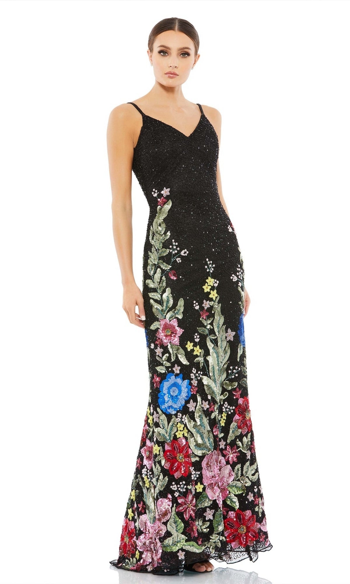 A woman wears the Mac Duggal 5475 Long Beaded Floral Formal Dress— a sleeveless black gown with thin straps and colorful sequin floral embroidery from the waist down.