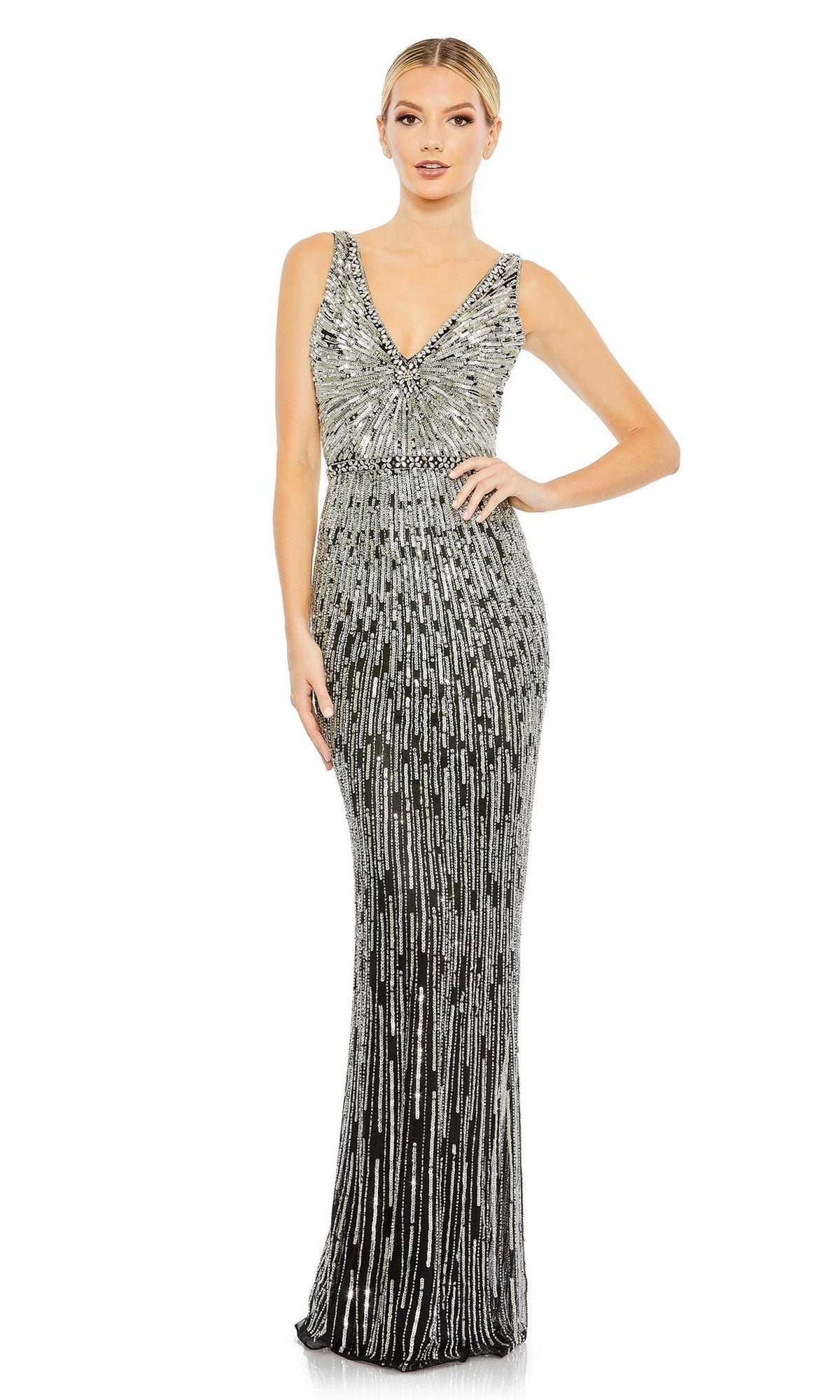 A woman stands against a white background wearing the Long Formal Dress 5483 by Mac Duggal, a sleeveless, fitted, floor-length v-neck gown covered in silver sequins.