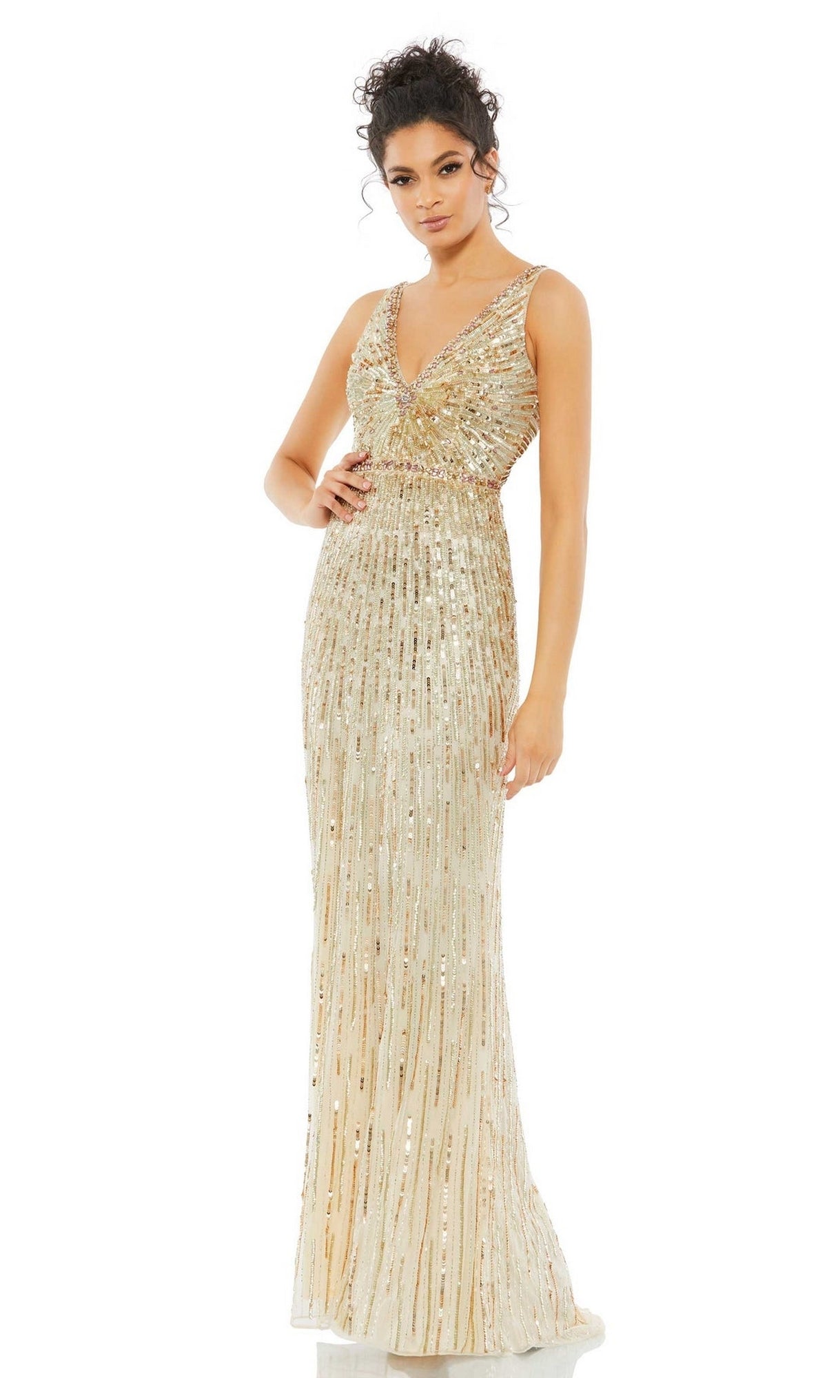 A woman wears the Long Formal Dress 5483 by Mac Duggal, a floor-length, sleeveless gown with gold sequins and a deep V-neckline, set against a plain white background.