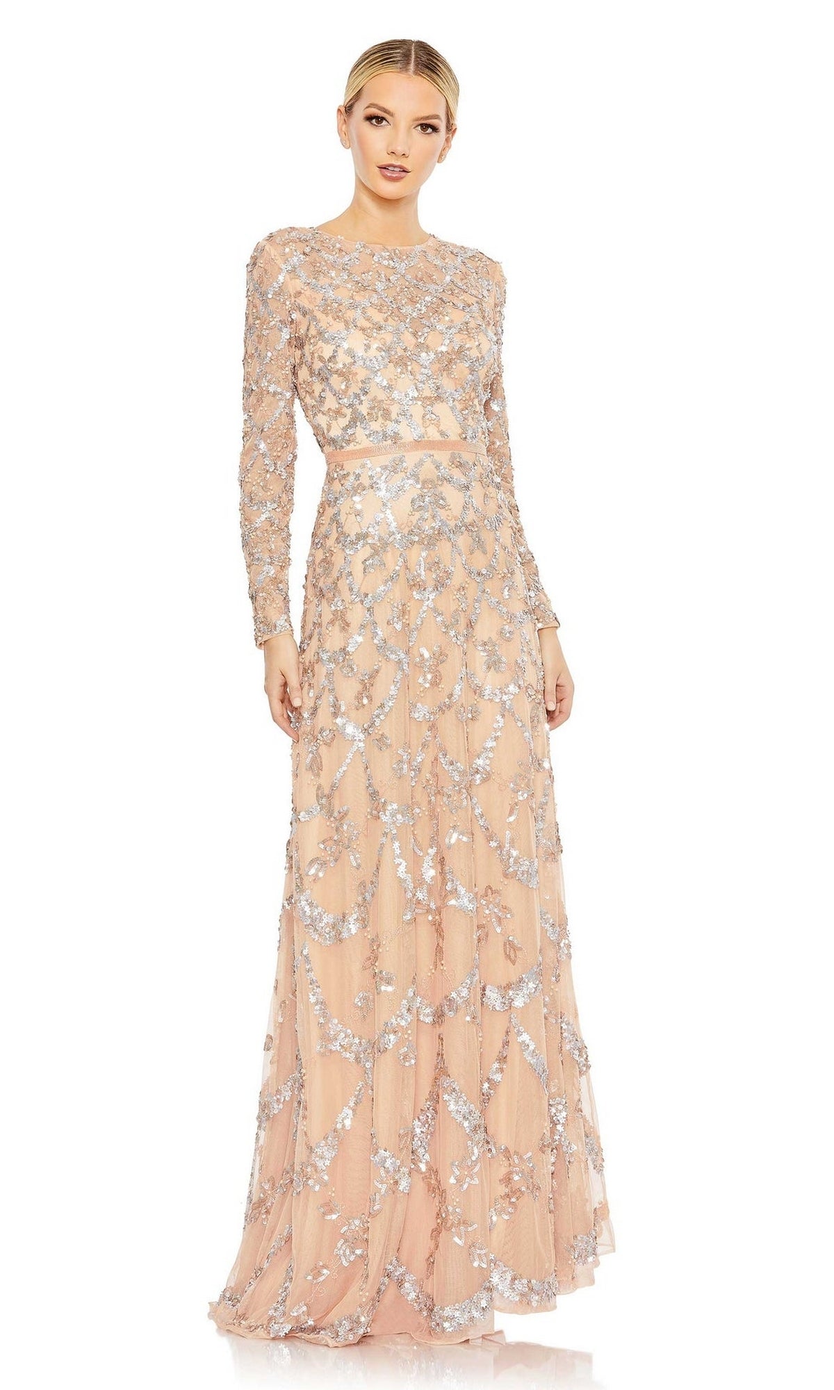 A woman wears the Mac Duggal 5496 Long Sleeve Sequin Formal Gown—a blush, floor-length dress with silver sequins and a fitted waist—against a white background. Ideal for mother of the bride or other formal occasions.