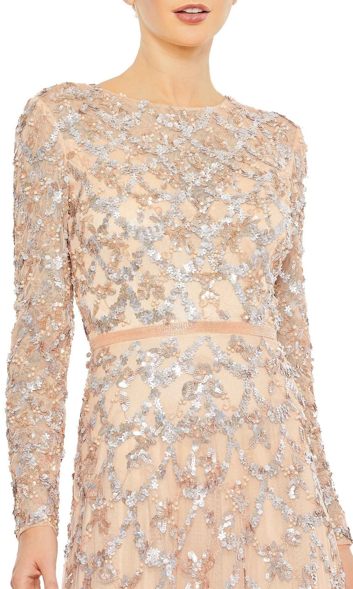 A mother of the bride wears the Mac Duggal 5496 Long Sleeve Sequin Formal Gown, a light beige dress with silver sequin floral patterns, shown from shoulders to waist.