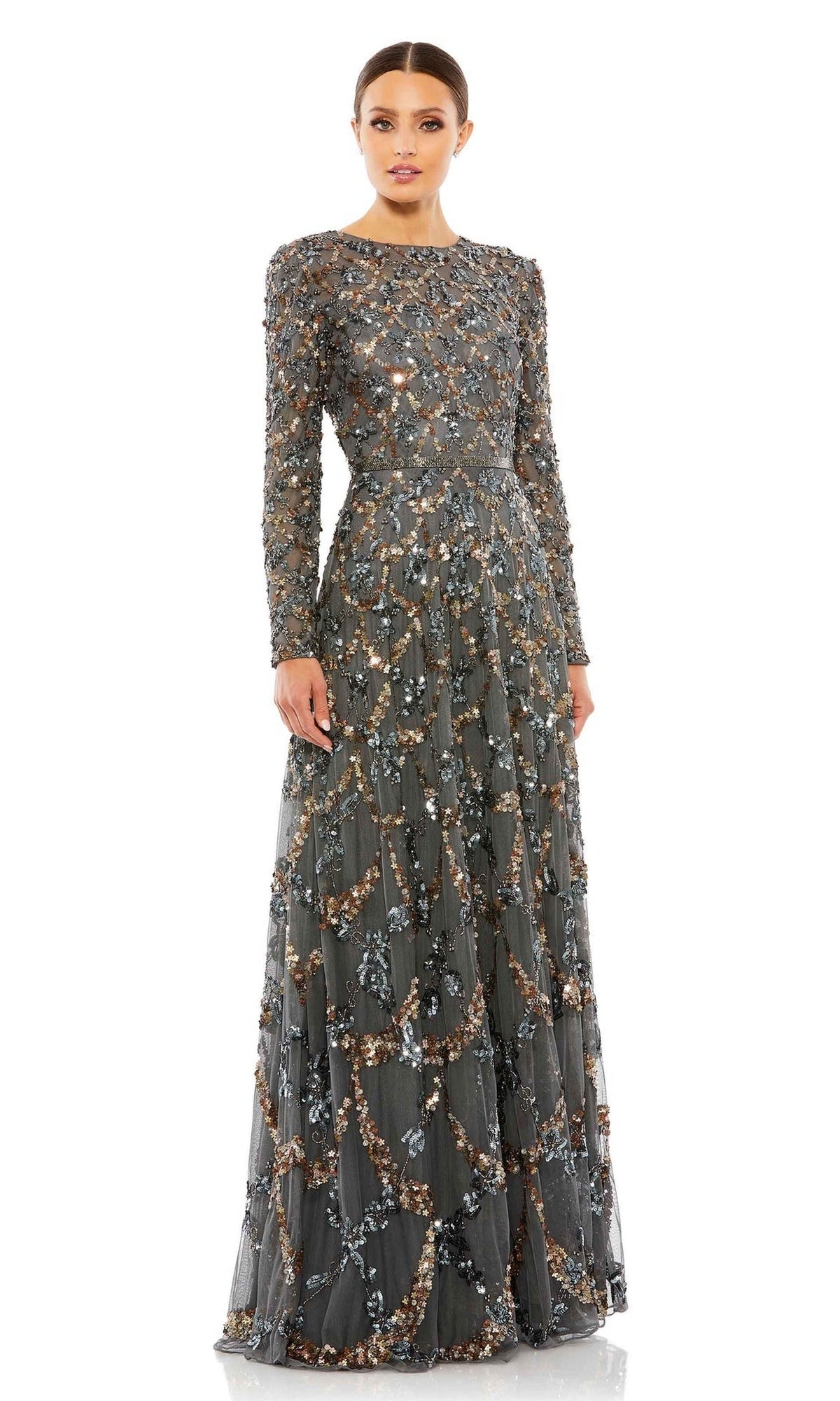 A woman stands facing forward against a white backdrop, modeling the Mac Duggal 5496 long sleeve sequin formal gown in dark gray—an elegant choice for a mother of the bride, featuring intricate bead and sequin embellishments.