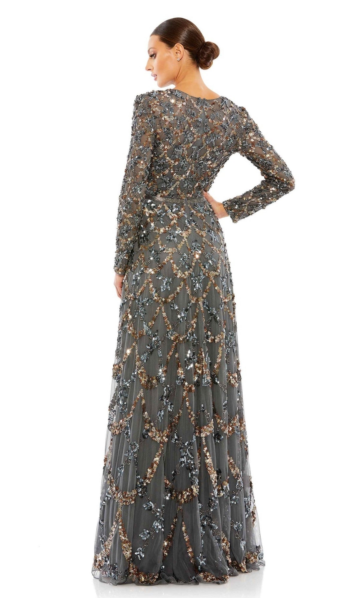 A woman faces away, wearing the Mac Duggal 5496 Long Sleeve Sequin Formal Gown with intricate scalloped bead and sequin embellishments—an elegant mother of the bride choice. Her hair is styled in a low bun.