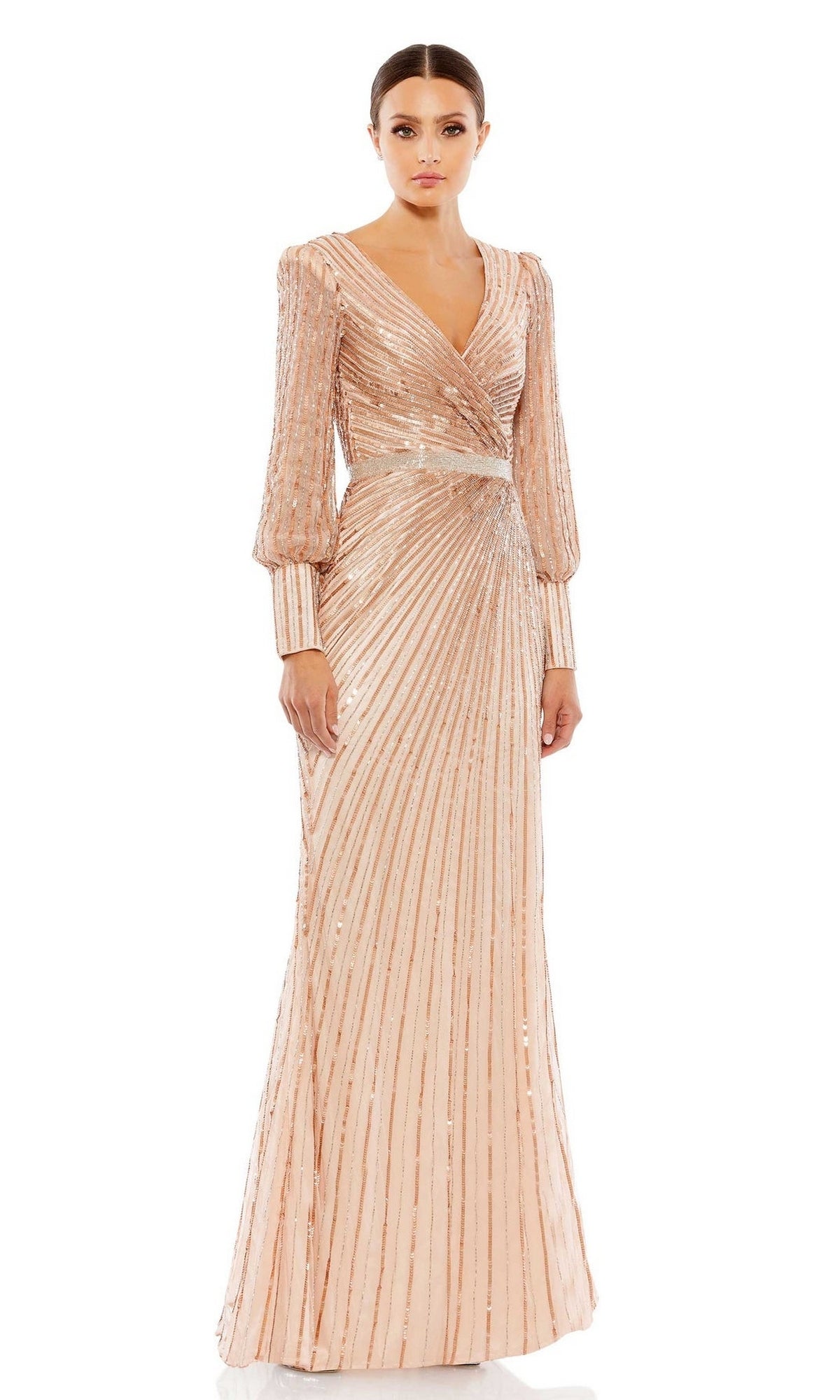 A woman wears the Mac Duggal 5501 Long Sleeve Sequin Formal Dress, featuring blush-hued metallic vertical stripes, a V-neckline, and long sleeves—an elegant choice for a mother of the bride.