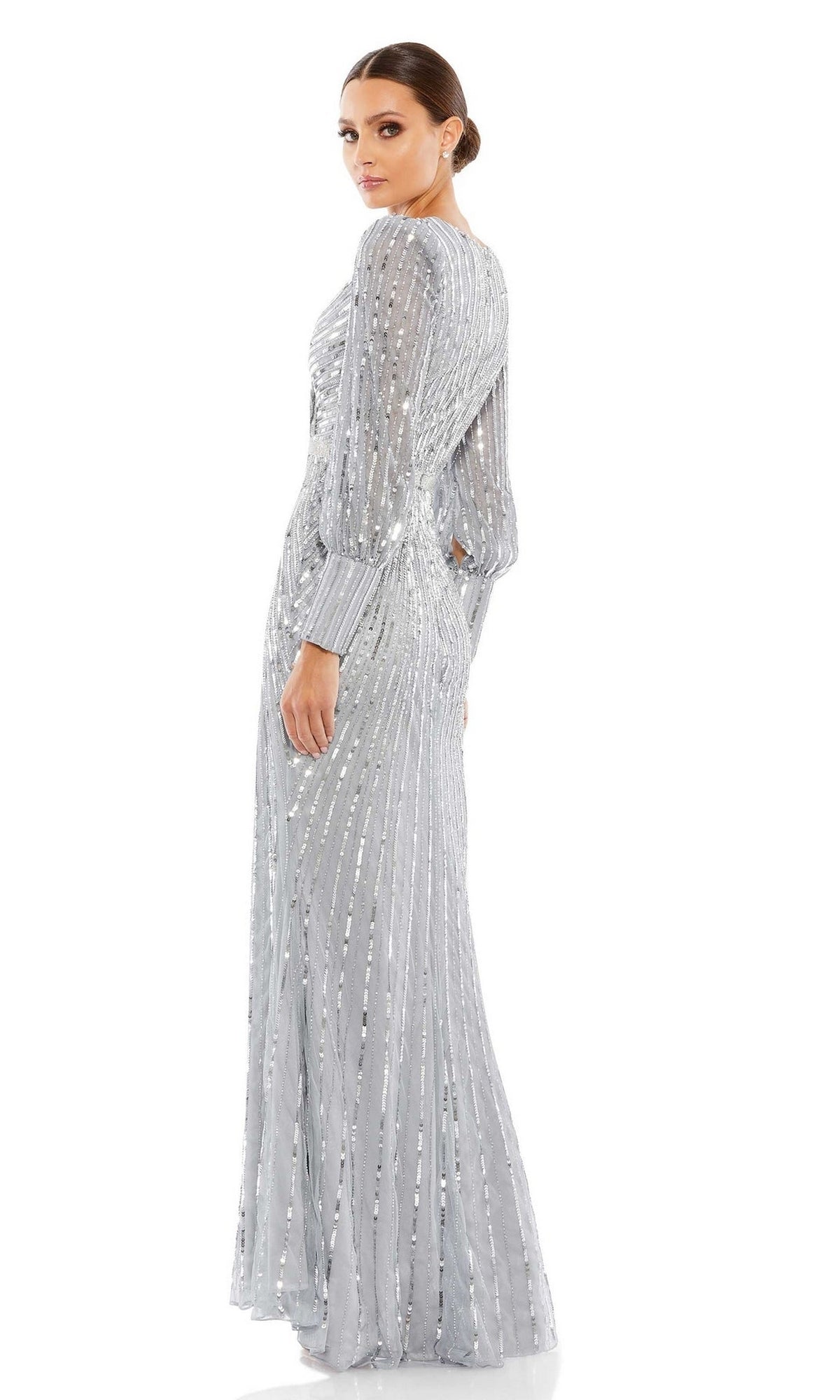 A woman poses in the Mac Duggal 5501 Long Sleeve Sequin Formal Dress, featuring a fitted waist—an elegant option for mothers of the bride or special evening occasions.