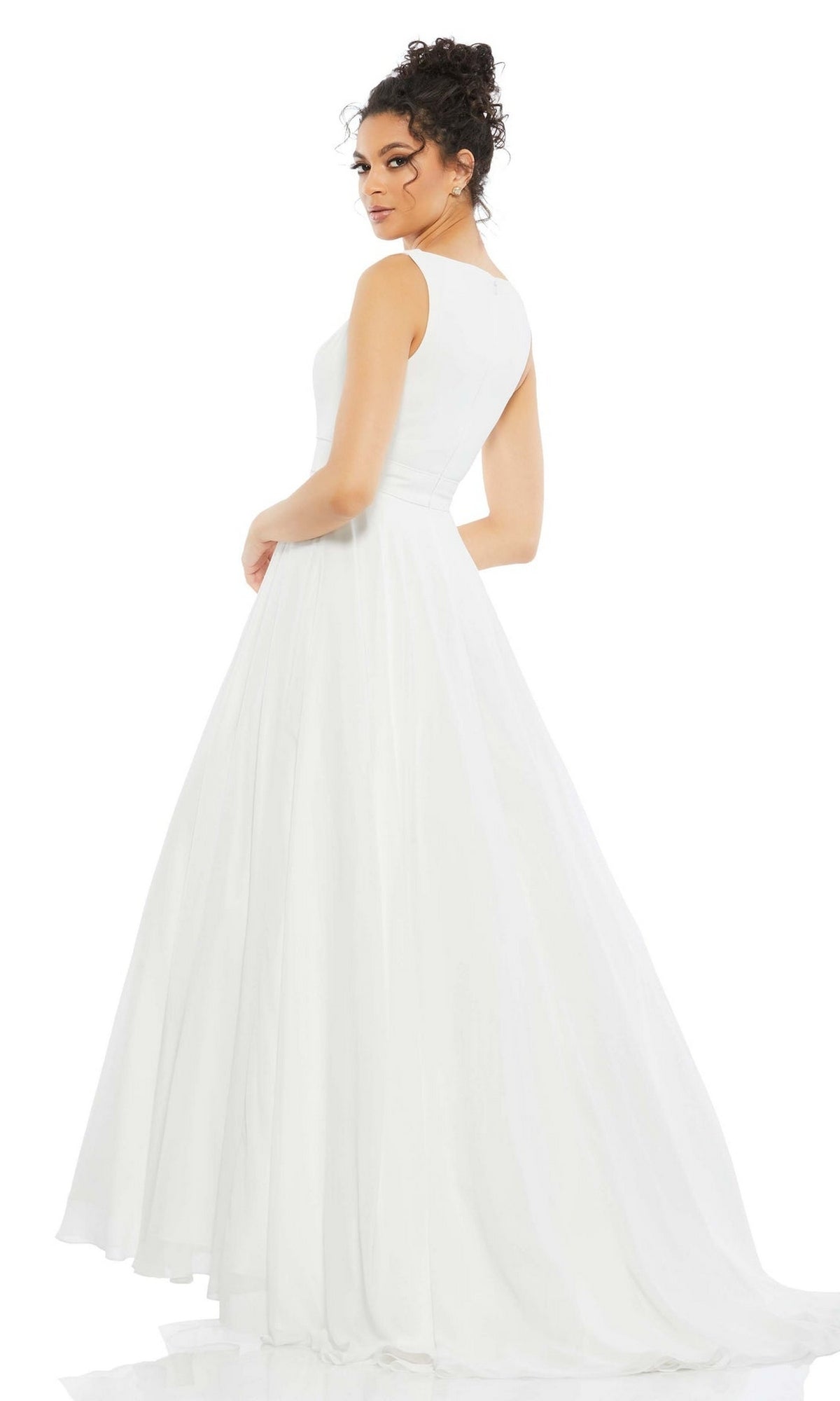 A woman in the Long Formal Dress 55272 by Mac Duggal, a sleeveless, floor-length white tulle ball gown, stands turned slightly away and looks over her shoulder against a plain white background.