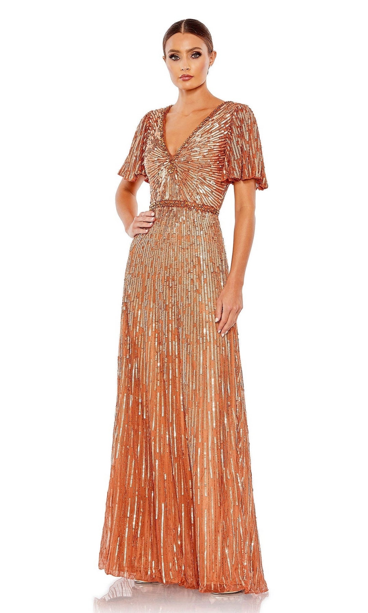 A woman stands against a white background wearing the Long Formal Dress 5538 by Mac Duggal, featuring metallic copper pleated fabric, butterfly sleeves, a V-neckline, and floor-length design.