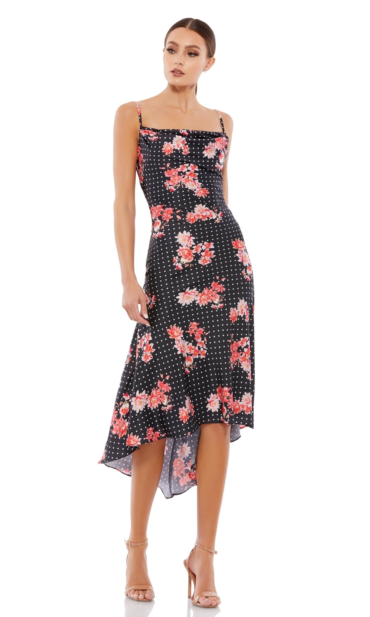 Woman wearing the Black Floral-Print High-Low Party Dress 55392 with red flowers and white polka dots, paired with nude heels and standing against a white background—a stunning choice for any party occasion.