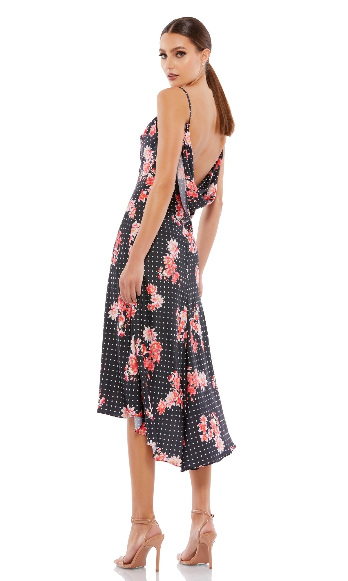 Woman wearing Black Floral-Print High-Low Party Dress 55392—sleeveless, backless with white polka dots and pink accents—paired with nude heels, making it the perfect dress for any party or special occasion.