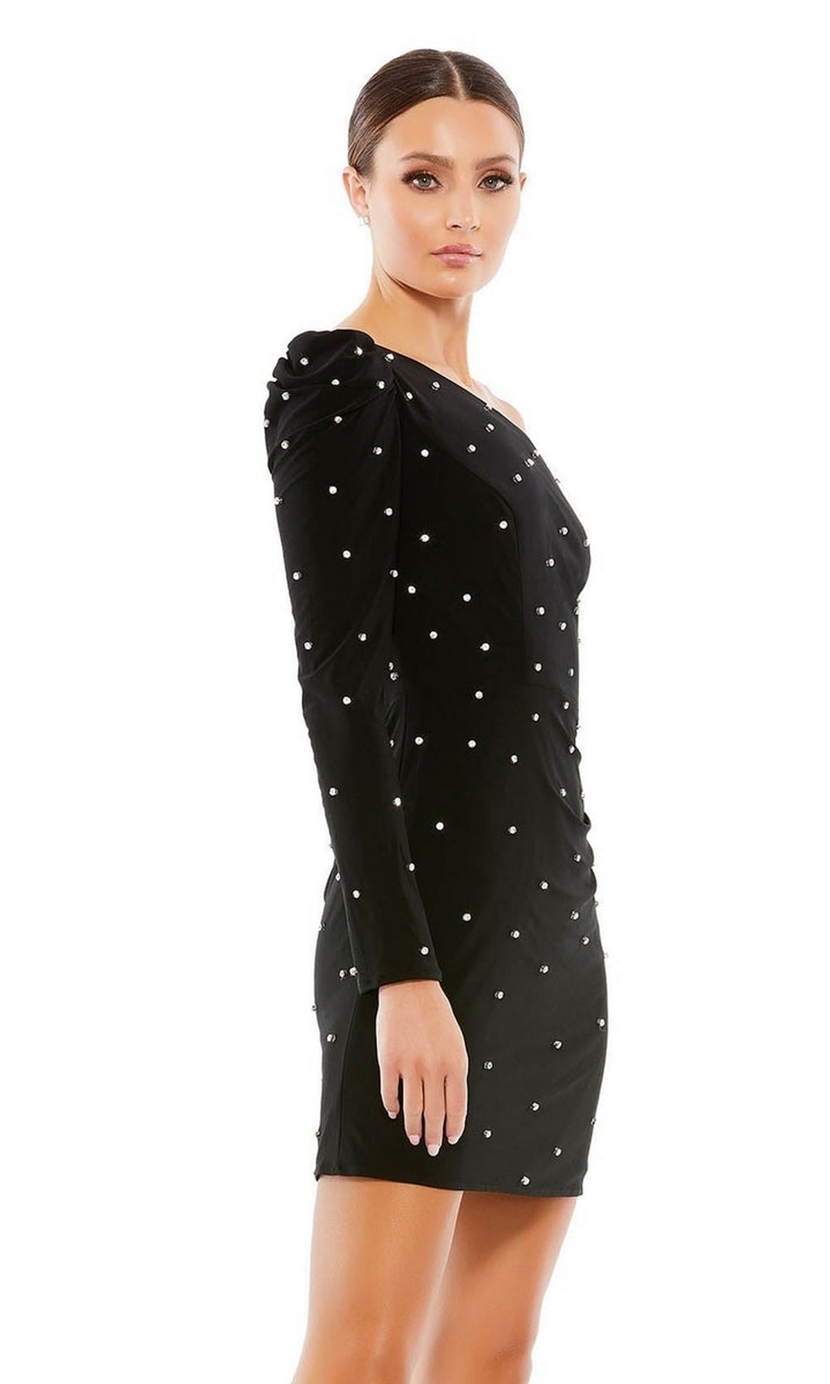 A woman stands against a white background wearing the Short Black Pearl Hoco Dress (Mac Duggal 55667), a fitted, long-sleeve black party dress embellished with white pearls.