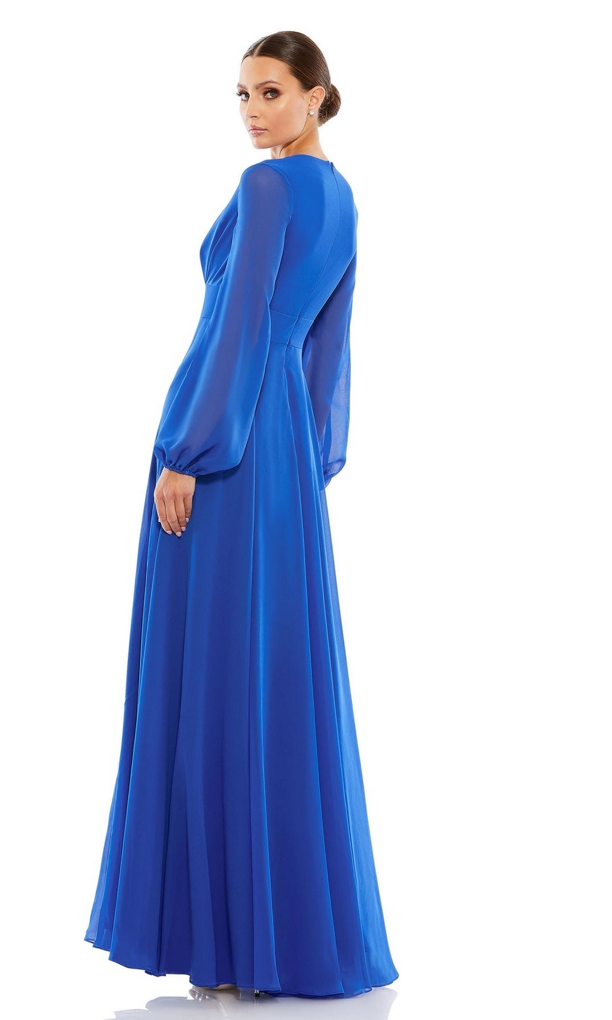 Woman looking over her shoulder, wearing the Mac Duggal 55682 long sleeve formal dress with sheer sleeves and a flowing chiffon skirt—the ideal mother of the bride dress—posed against a white background.