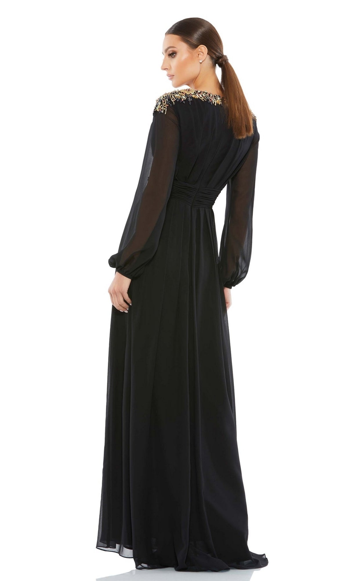 A woman wears the Mac Duggal 55694 long sleeve chiffon formal dress, featuring sheer sleeves and embellished shoulders—a sophisticated option for a mother of the bride.