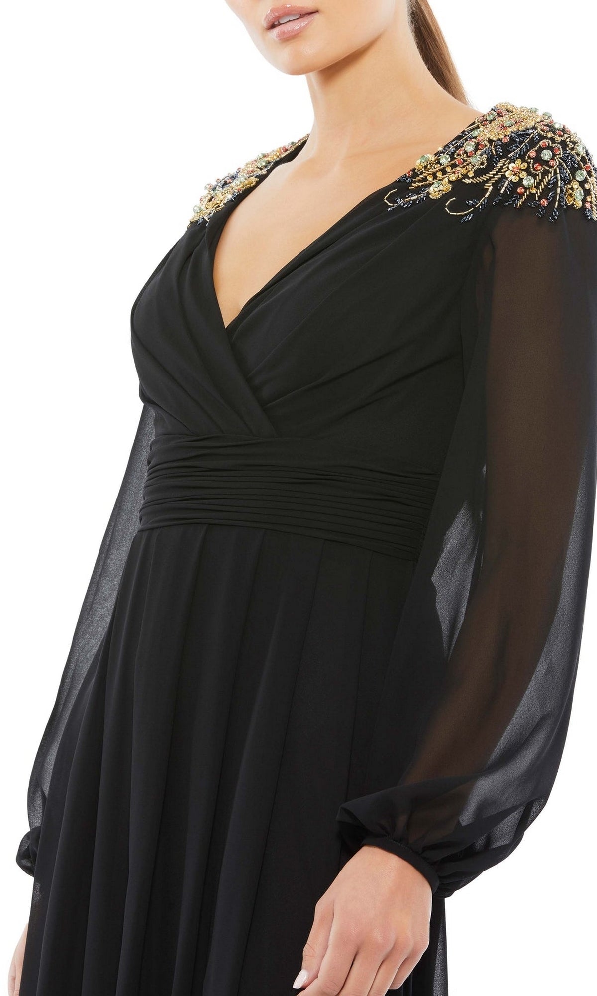 A woman models the Mac Duggal 55694 long sleeve chiffon formal dress with sheer sleeves and embellished shoulders, shown from mid-torso up against a white background.